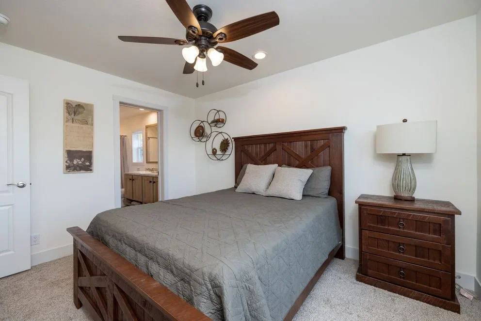 master bedroom photo inside the johnny be goode with queen bed in frame leading into the mater bathroom 