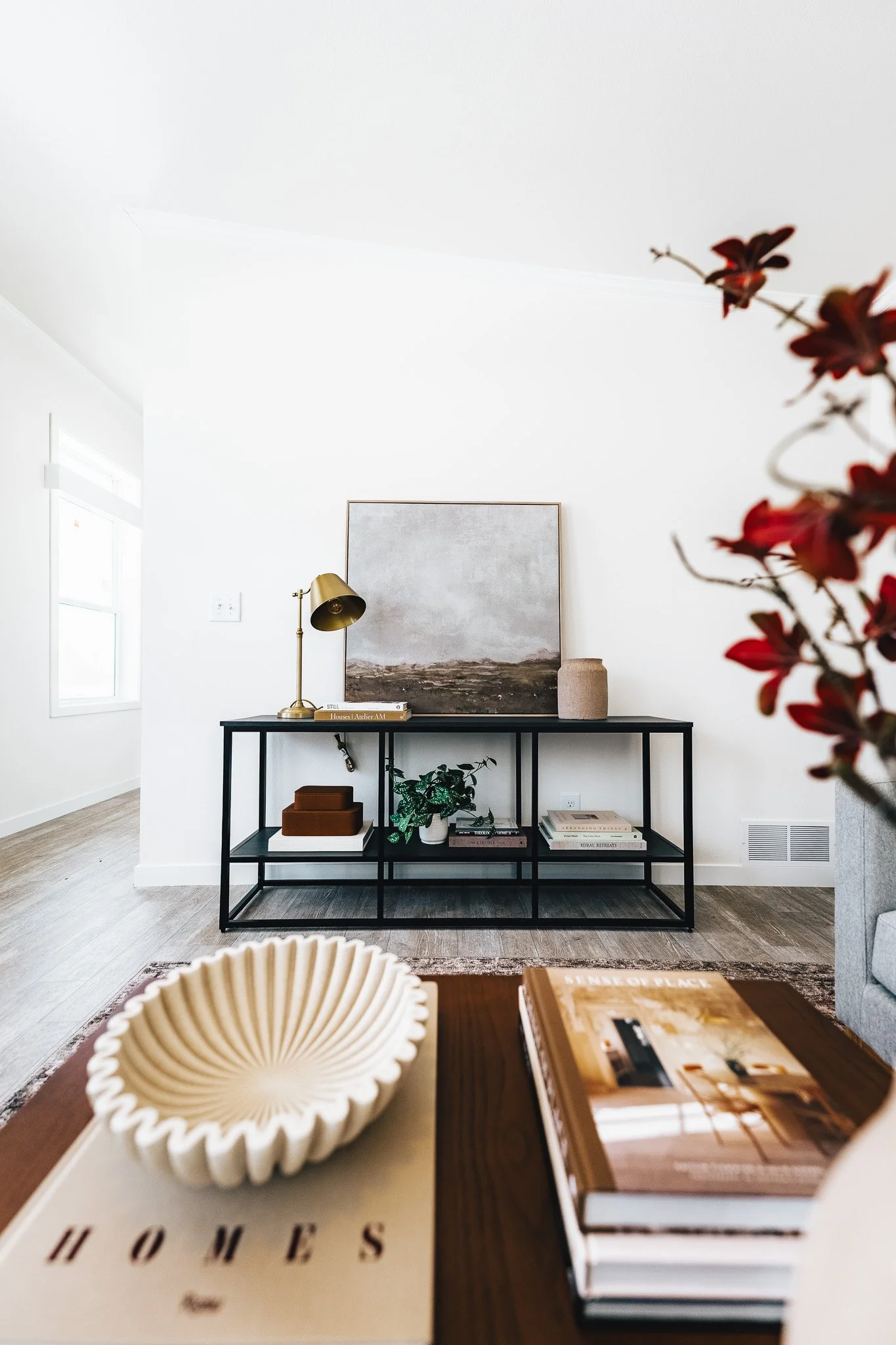 coffee table and wall table holding art in the photo 