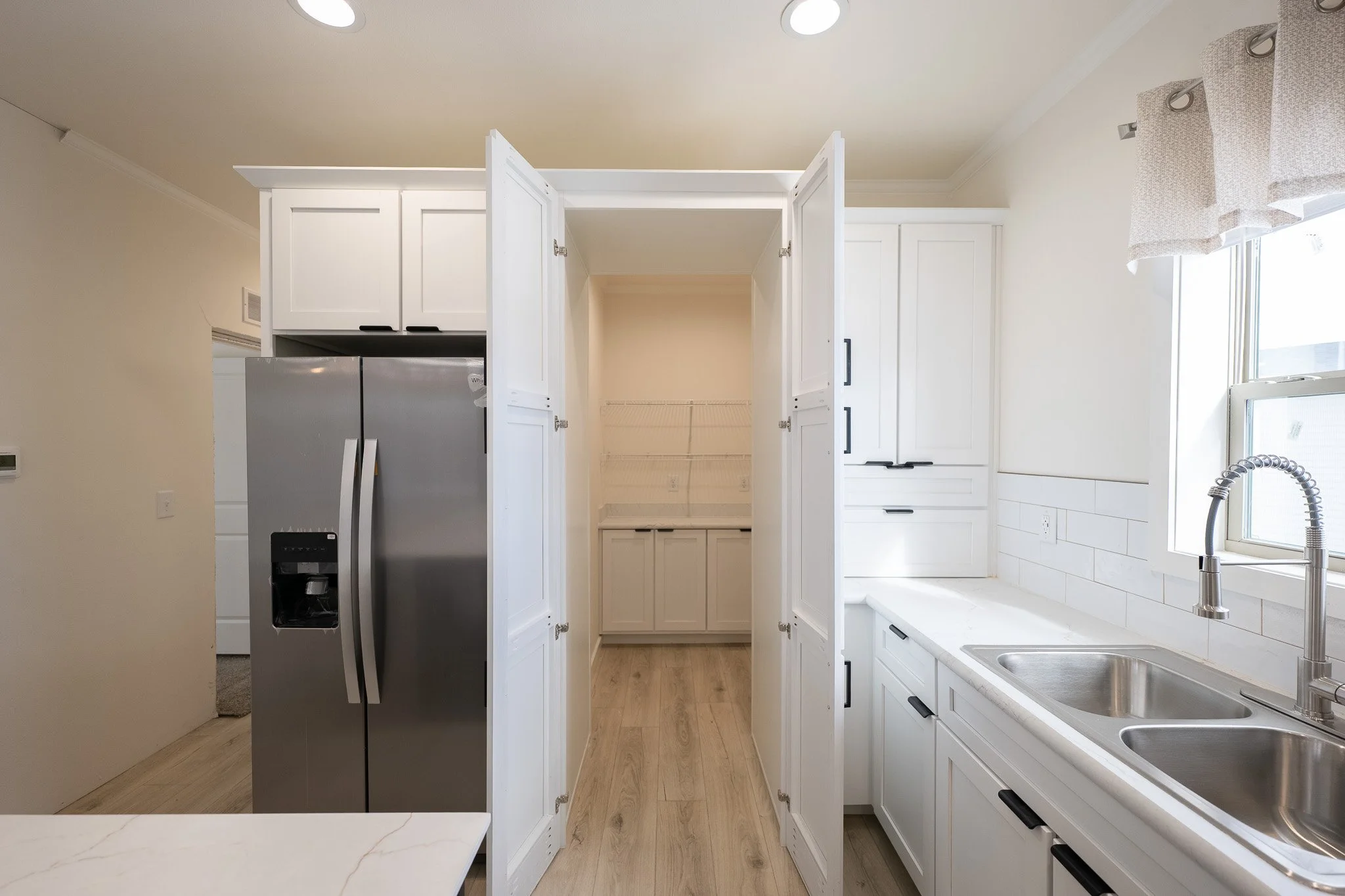 large hidden walk in pantry insid ethe kitchen of the cavco dakota manufactured home 