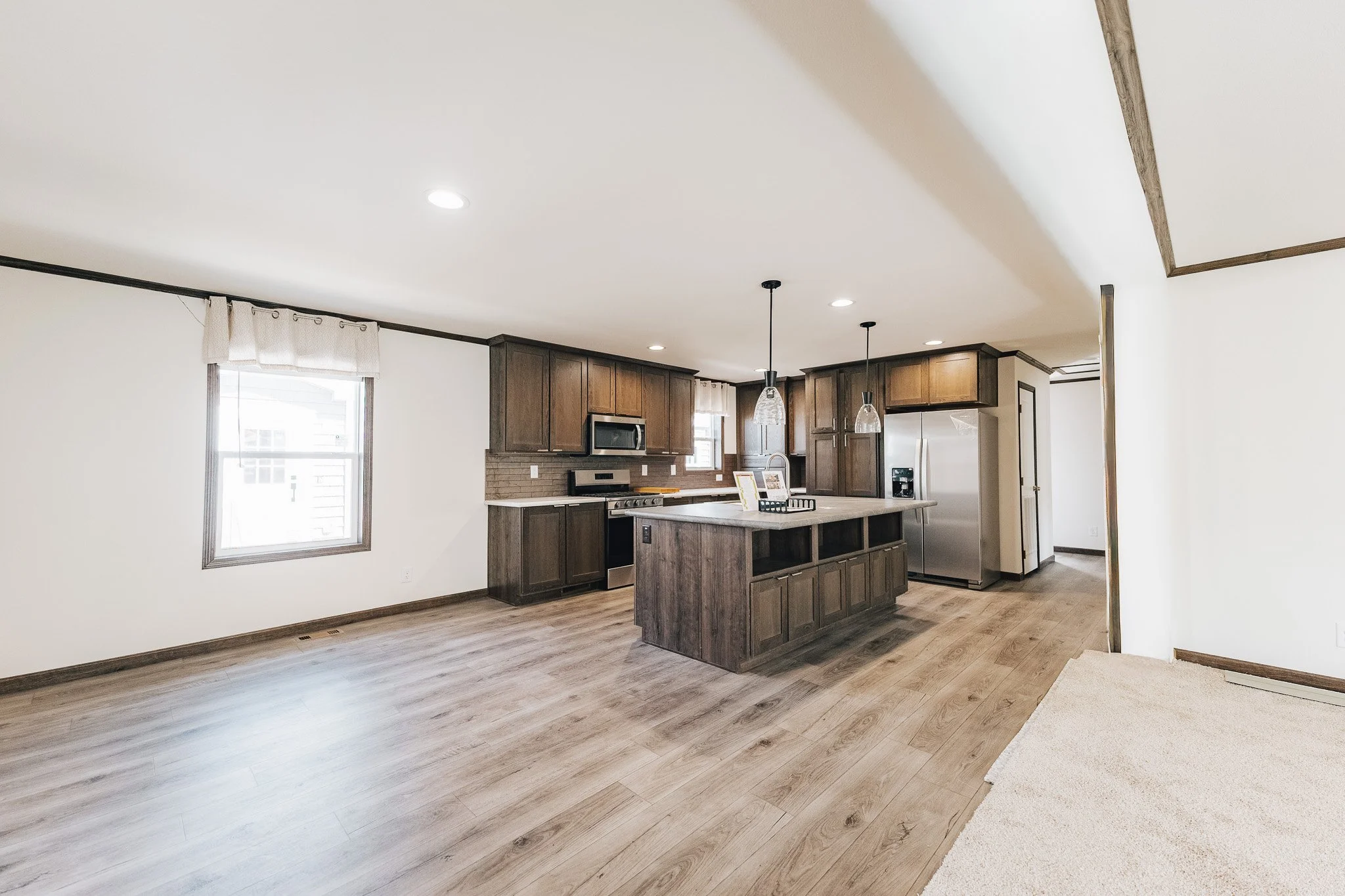 kitchen photo with gray cabinets and dinning room area to the left side of the photo