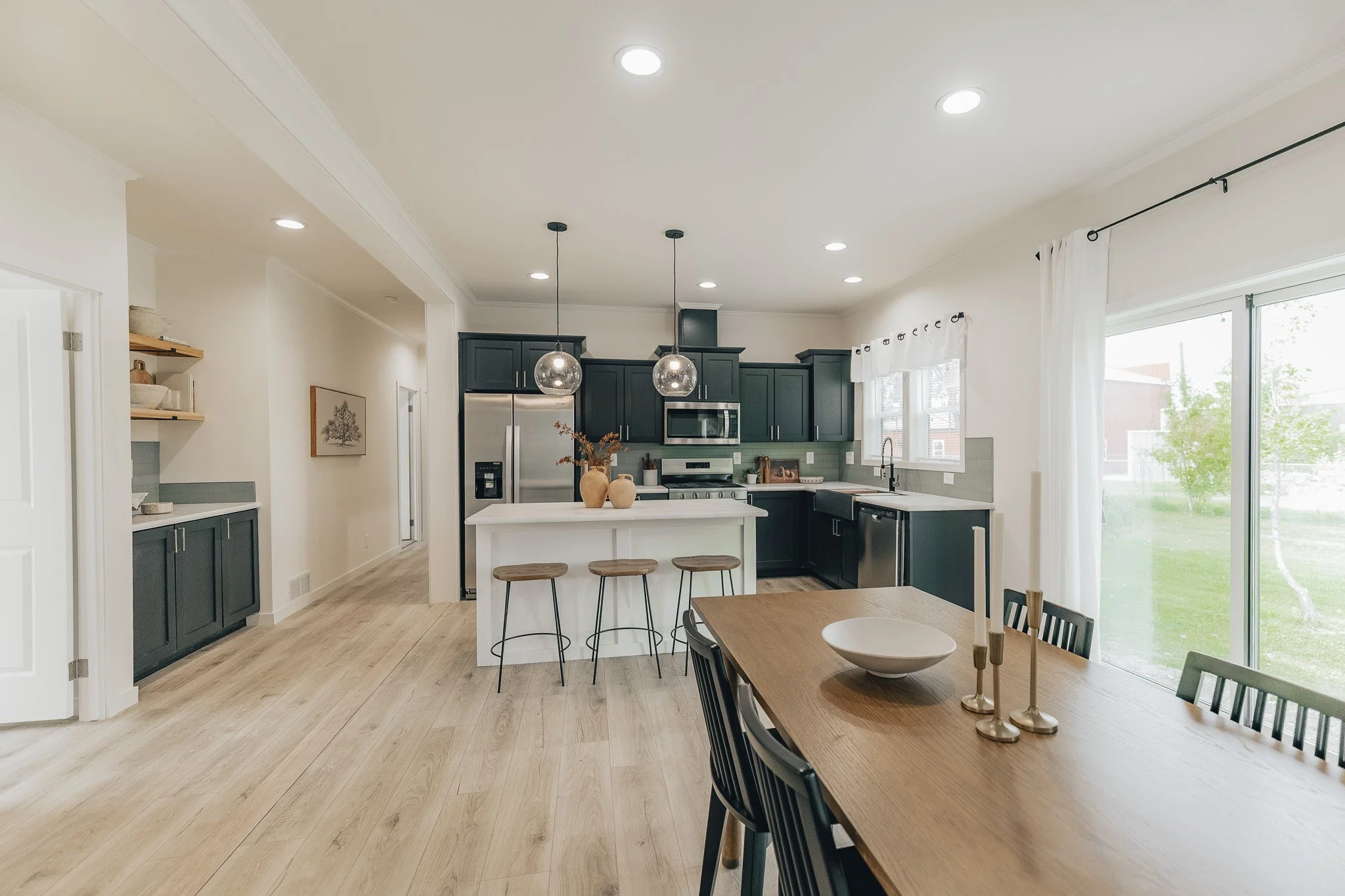 kitchen photo with black and white acents with modern lighting in the cavco farmhouse manufactured home