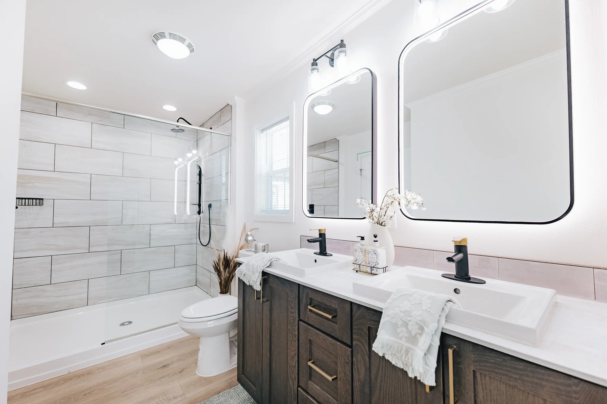master bathroom photo with duel vanity and large walk in shower with glass wall 