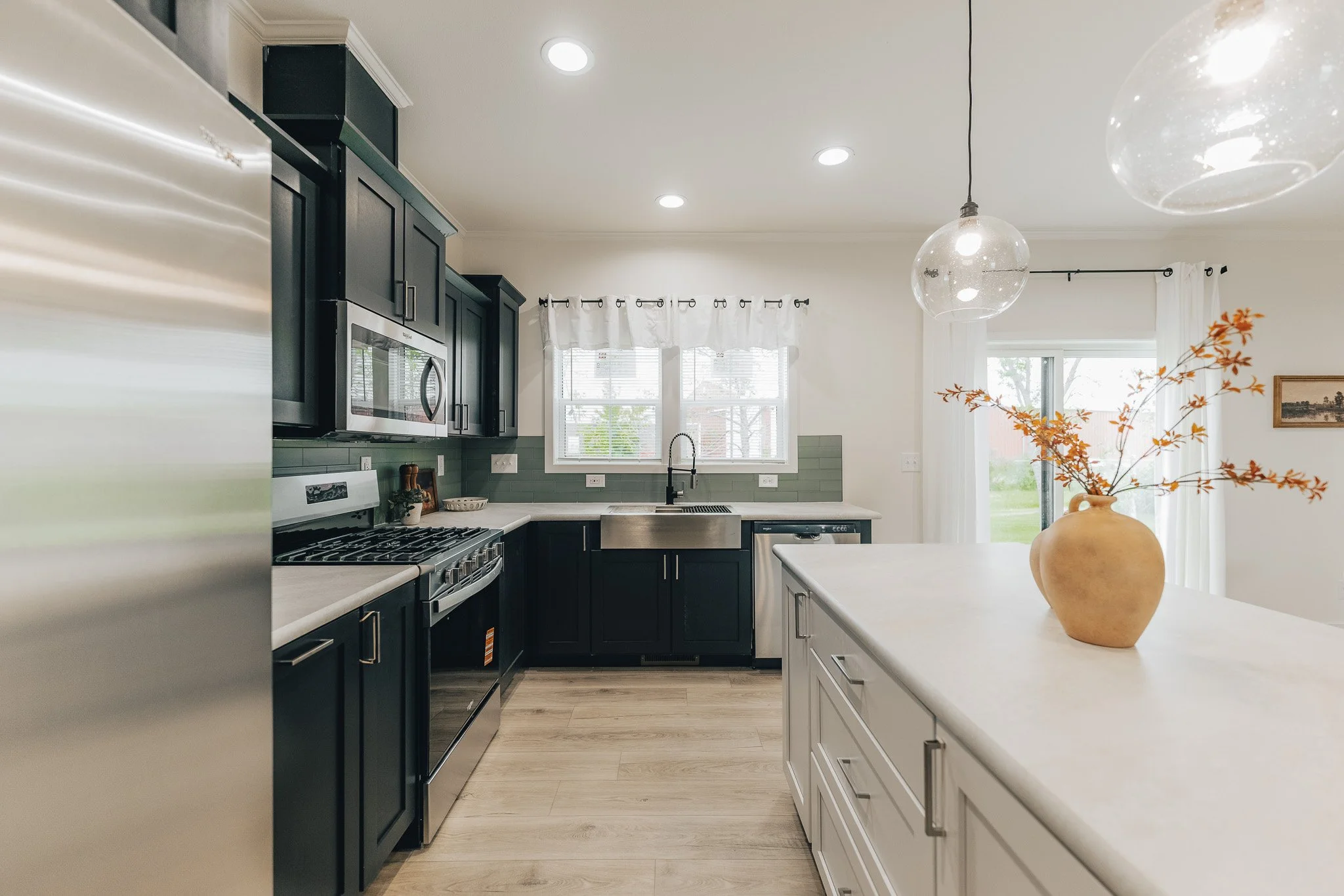 kitchen photo with black cabinets and stainless steel appliances inside the cavco manufactured home.