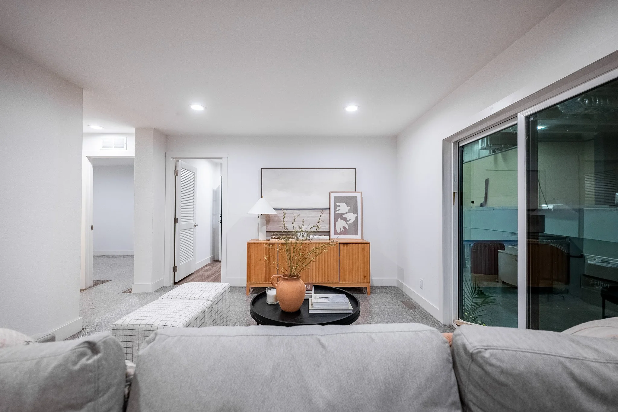 secondary livingroom photo with sidling glass door and utility room 