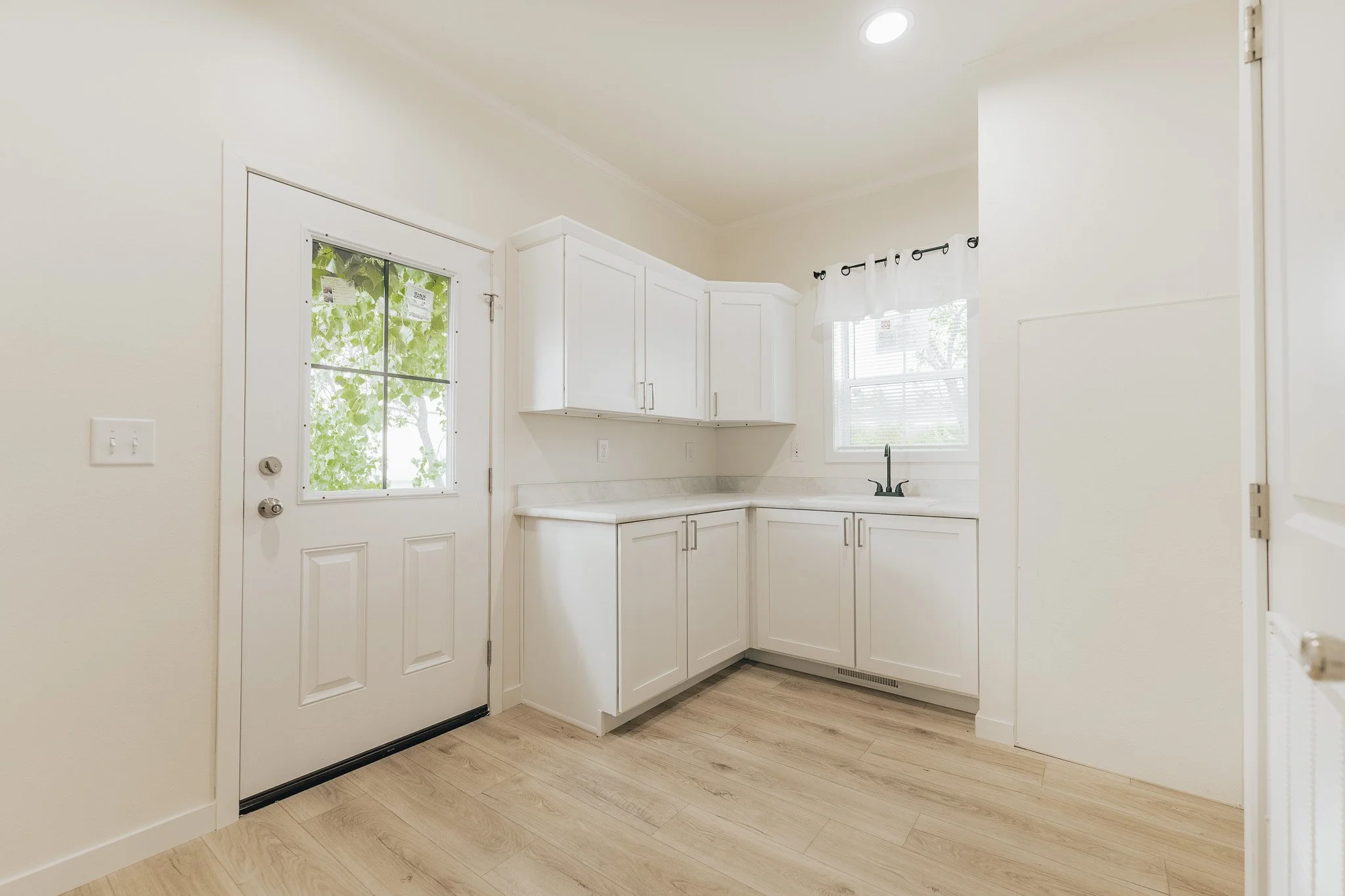 laundry room with upper and lower cabinets cavco manufactured home
