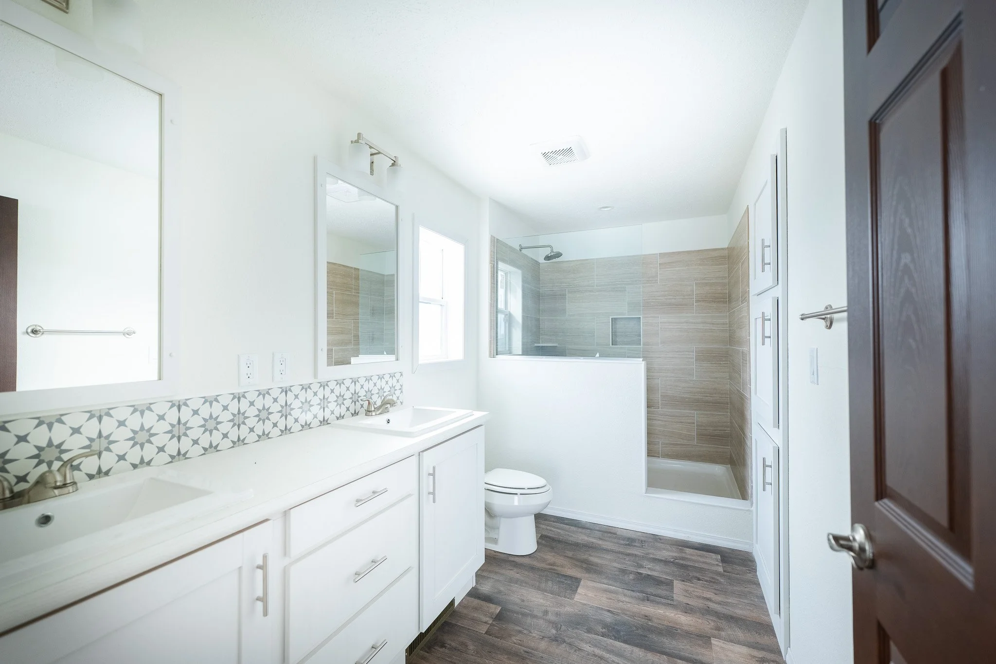 master bathroom photo with duel vanity and half wall walk in tiled shower 