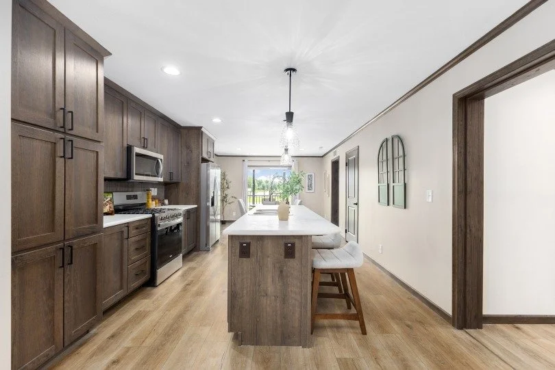 kitchen photo with island and gray cabinets inside the cavco manufactured home 