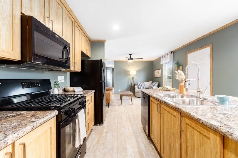interior photo of kitchen with light brown cabinets cavco singlewide 14763C