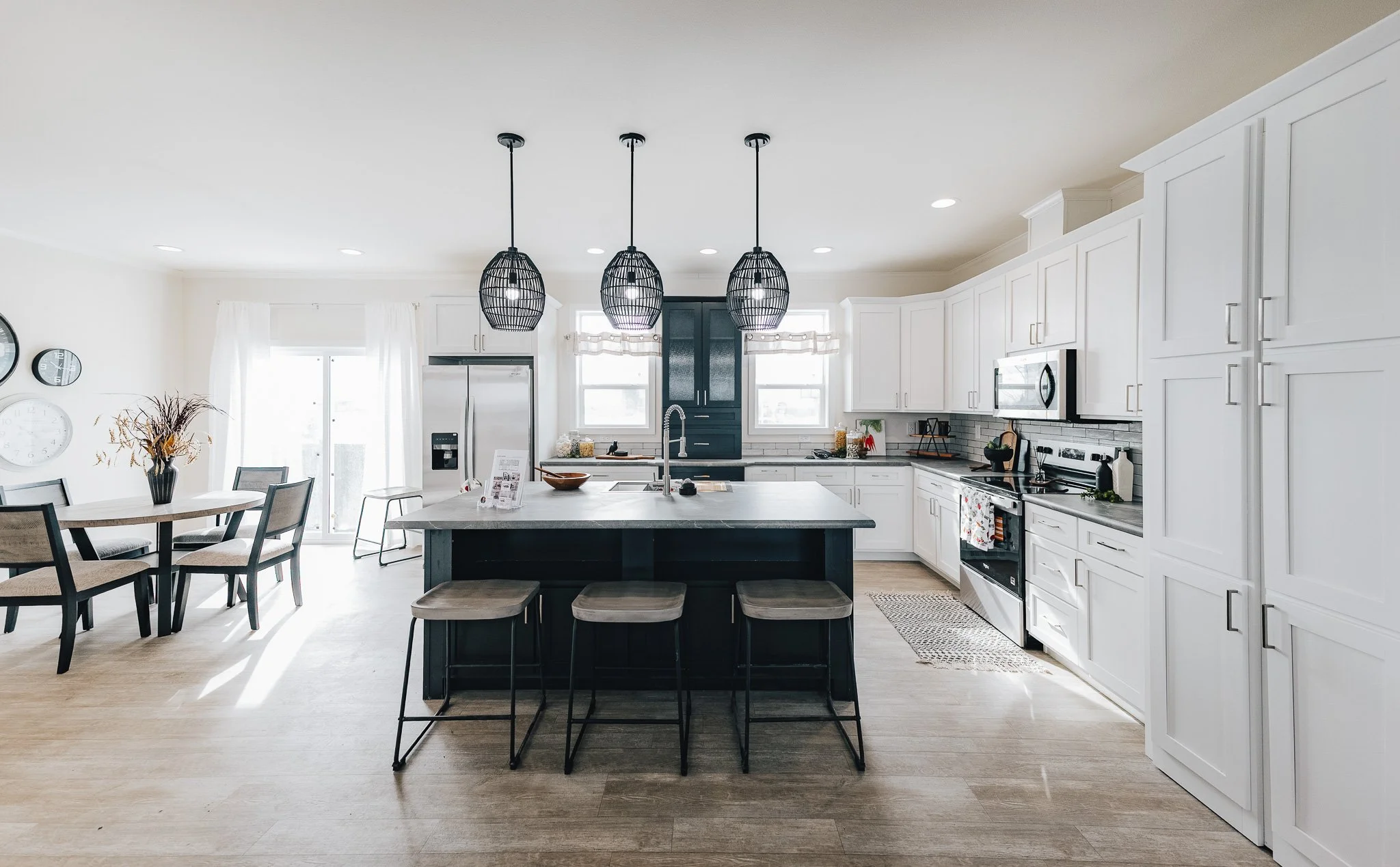 kitchen photo of white cabinets and kitchen island inside cavco sapphire manufactured home