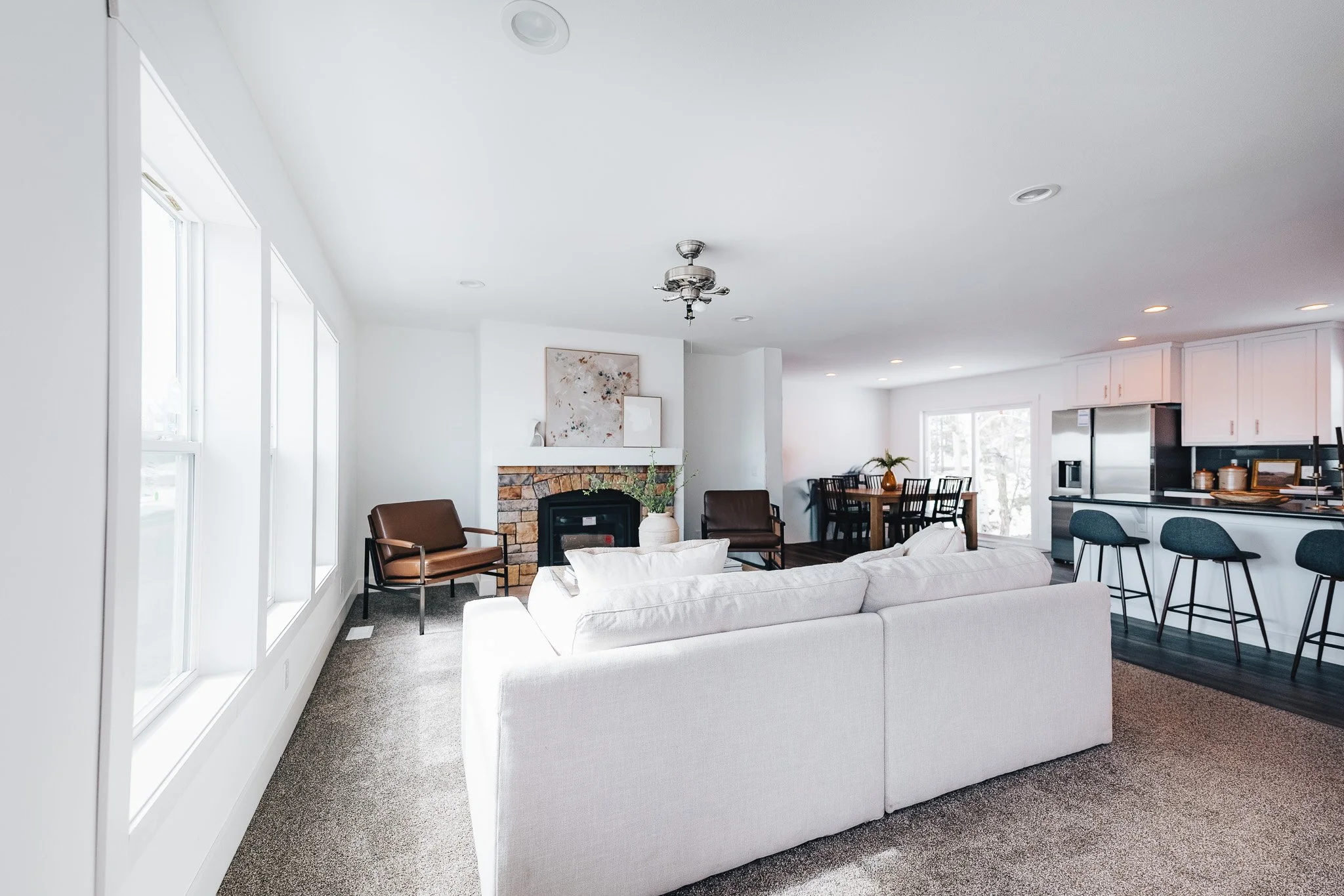 livingroom with white love seat facing a brick boardered fire place inside the schult legend 327