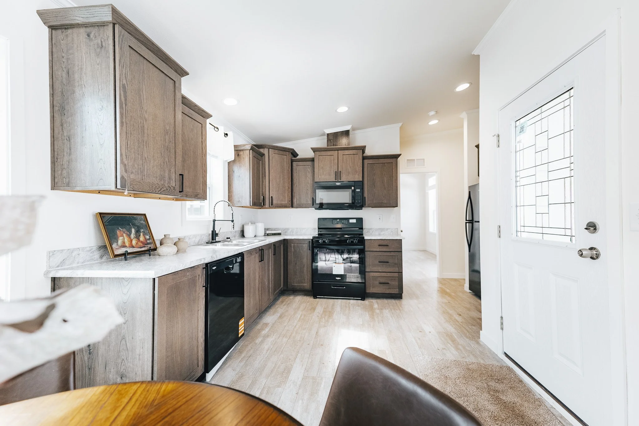 photo of the cavco kitchen right by the front entrance with gray brown cabinets inside cavco westlake ranch retreat 