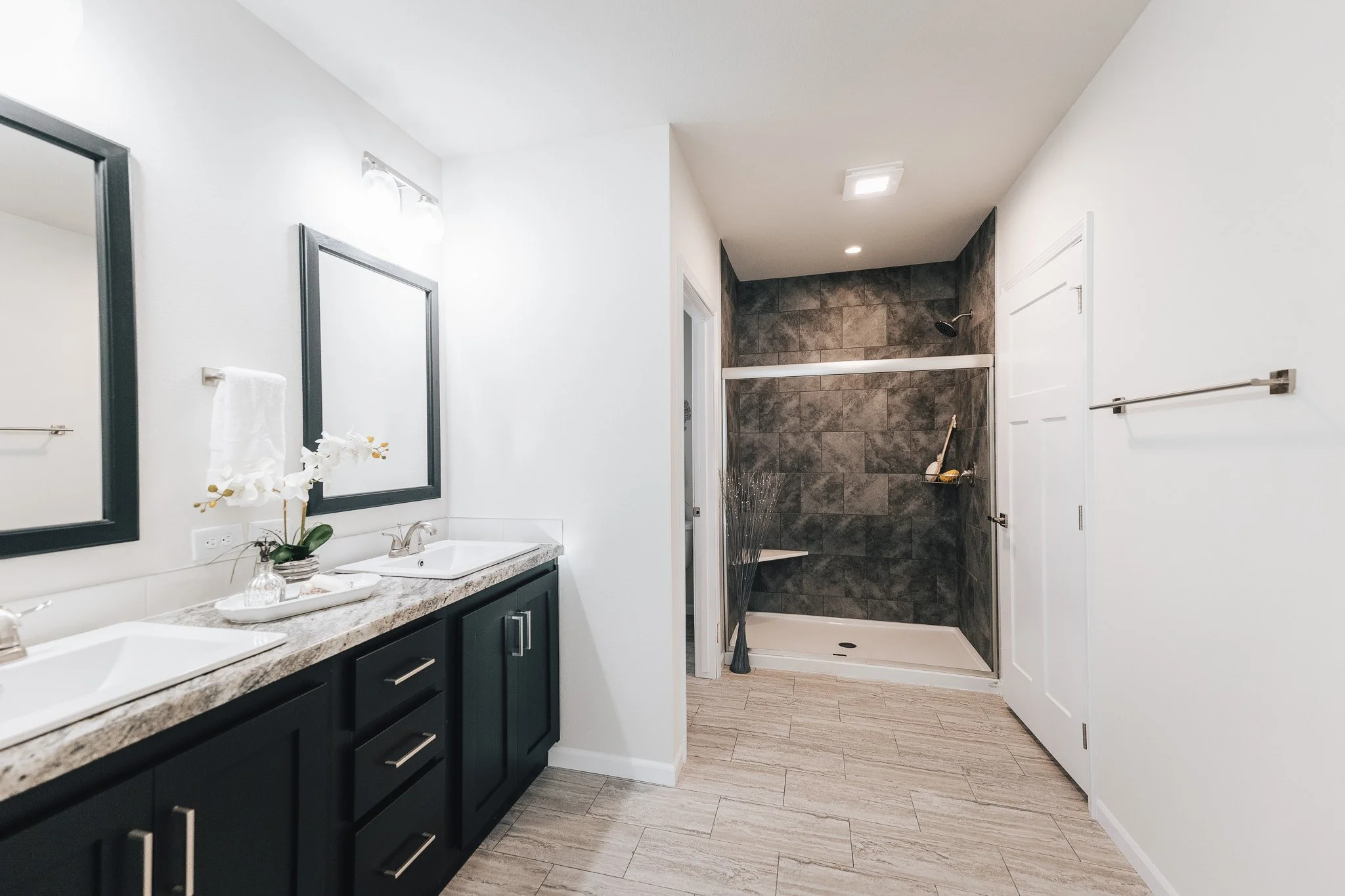 master bathroom with double vanity and walk in tiled shower inside the bonnaVilla 2764 Premier Limited