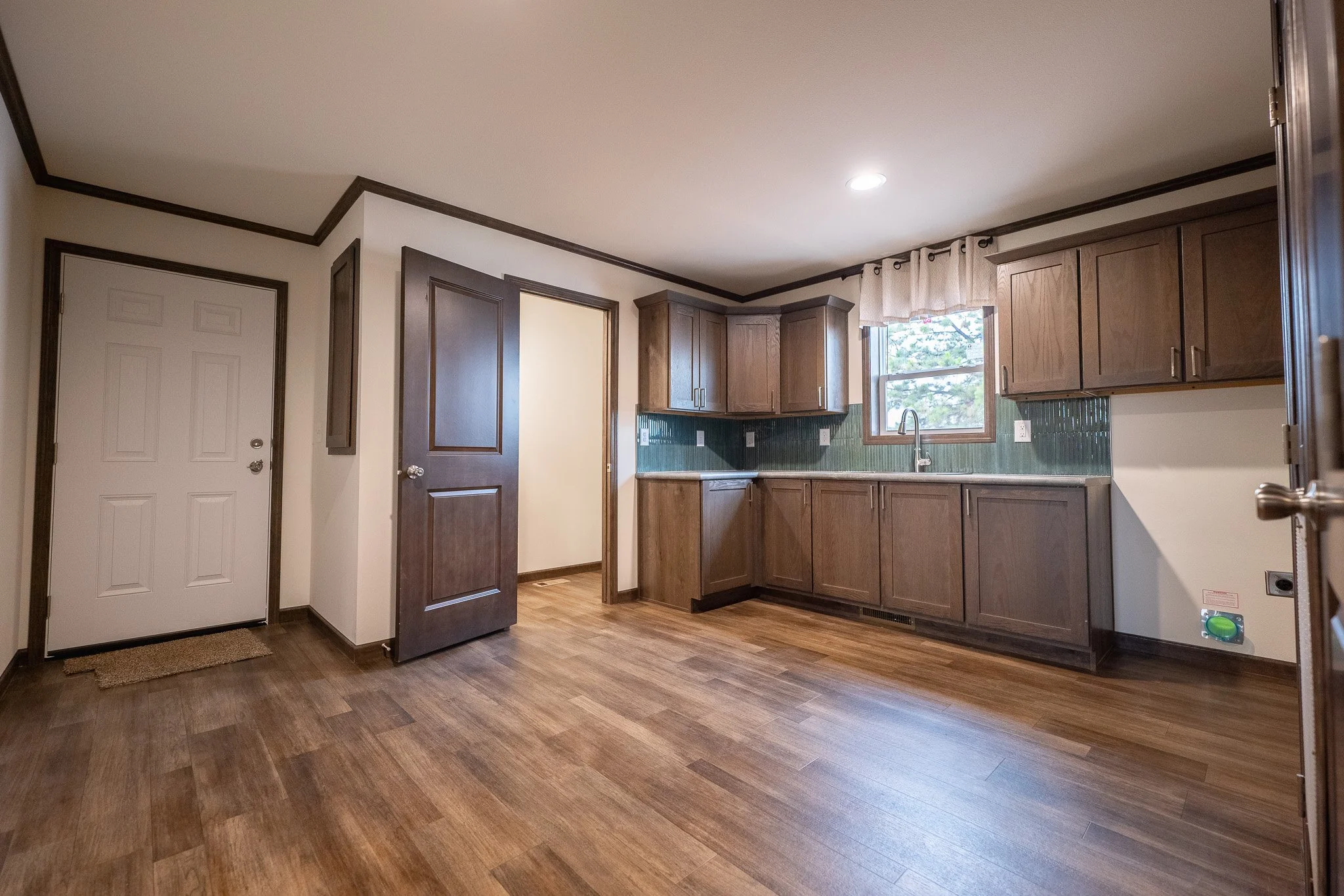 large laundry and utility room inside the cavco rushmore with half bathroom 