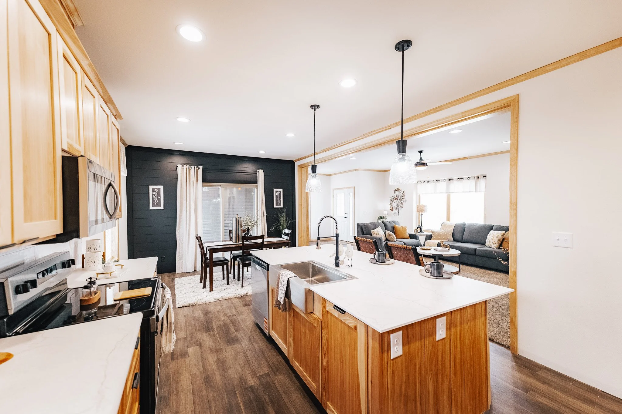 kitchen to livingroom with a view of the walk out into the covered deck in the cavco dakota edge 