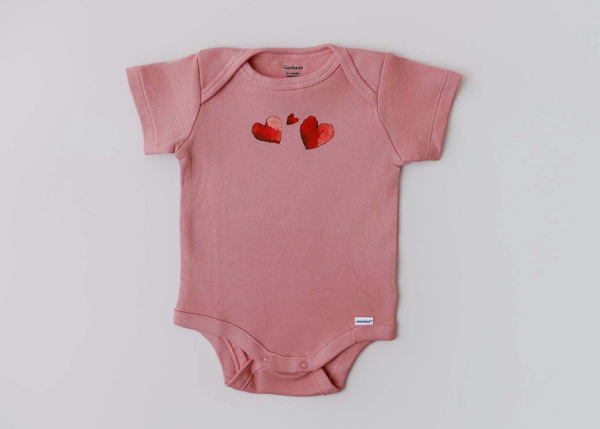 Sweet Hearts – 0-3 Months Short-Sleeve Onesie (Blush Pink)
