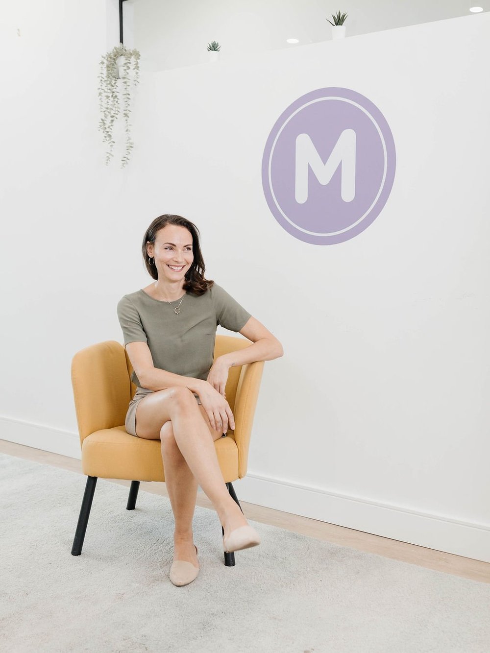 Inside the MINTY shop in Burlington, with the MINTY logo on the wall