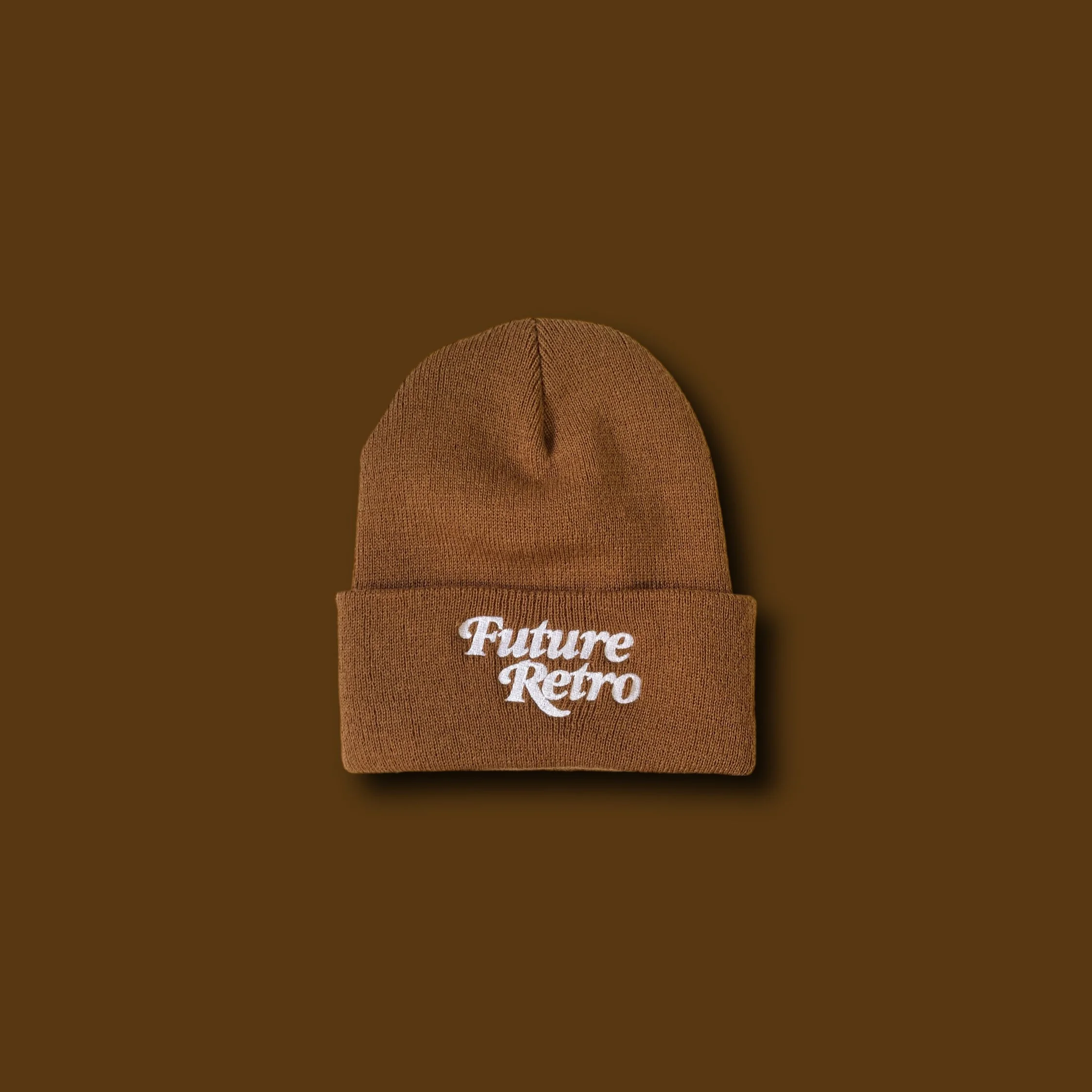 Brown knit beanie with white embroidered text reading 'Future Retro' on the front, against a brown background.