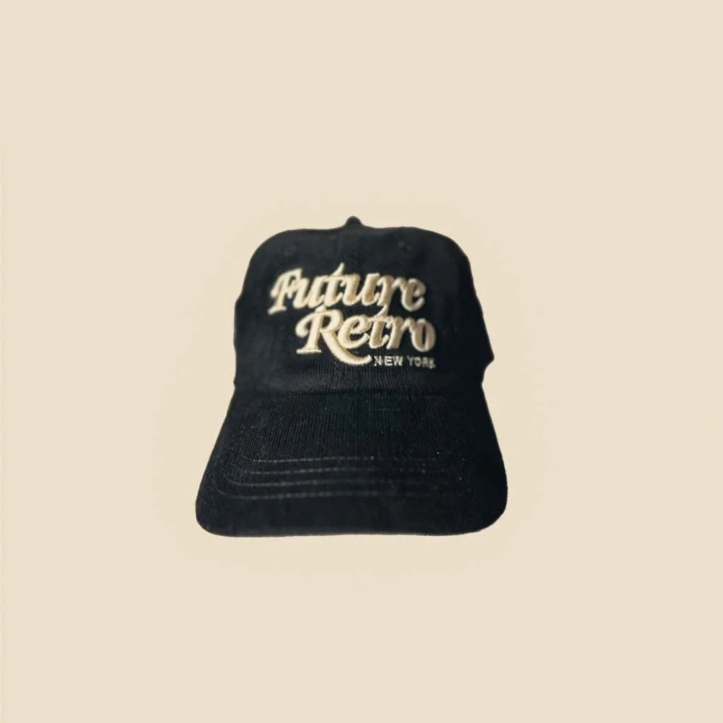 Black baseball cap with white embroidered text 'Future Retro New York' on the front.