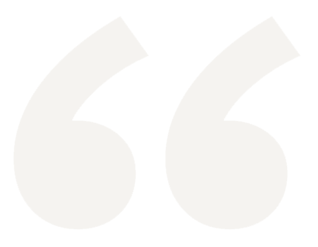 Large light beige quotation marks on a blank background.