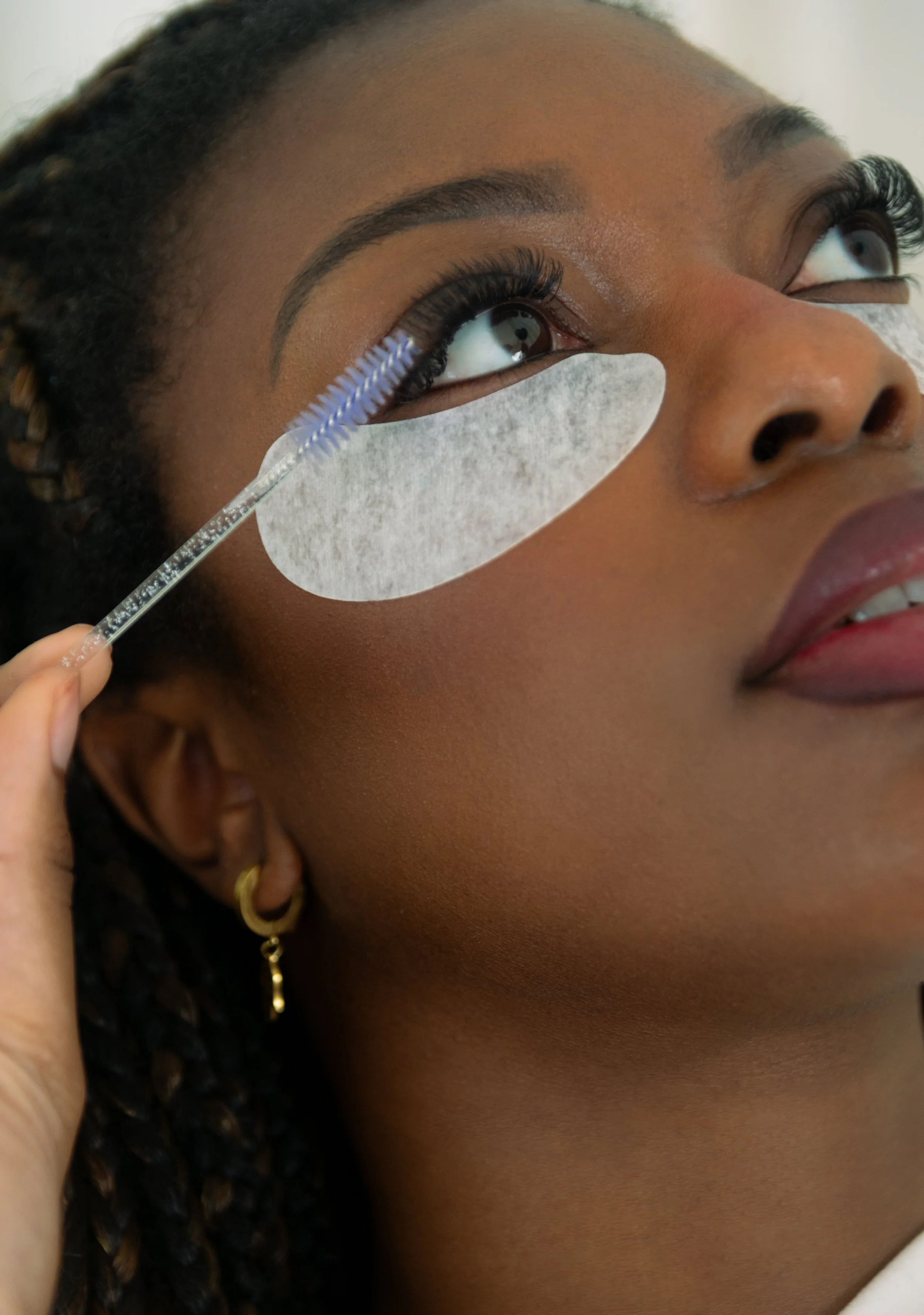 Lash extension appointment at Indigo Beauty Spa Aventura Miami — spoolie brush and under-eye pads during lash service
