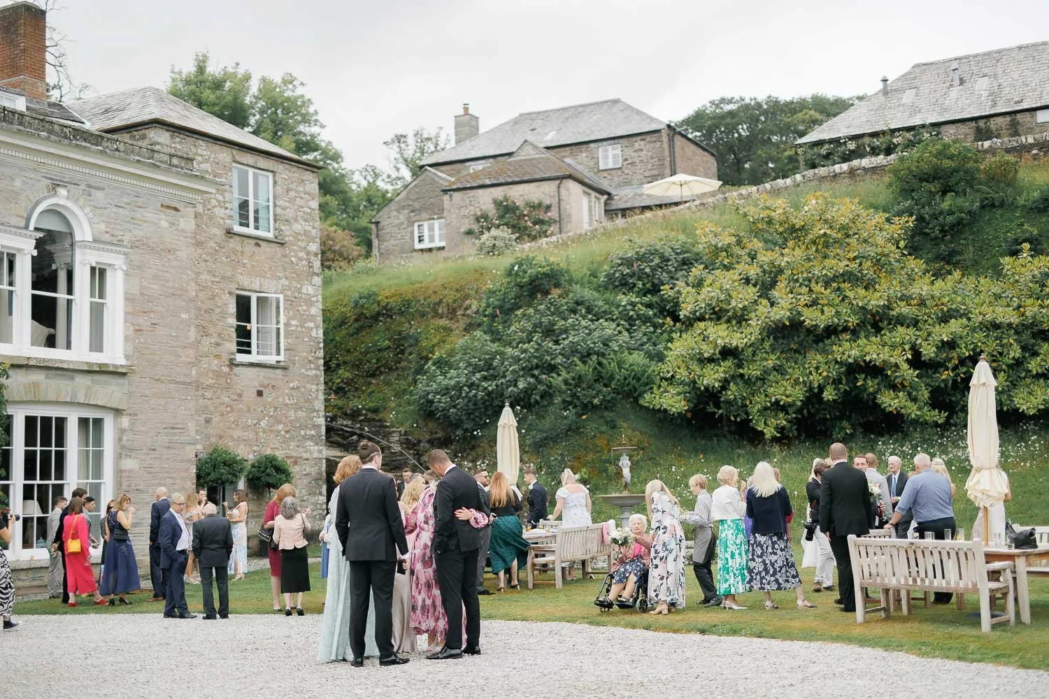wedding guests on lawn outside of Boconnoc Estate