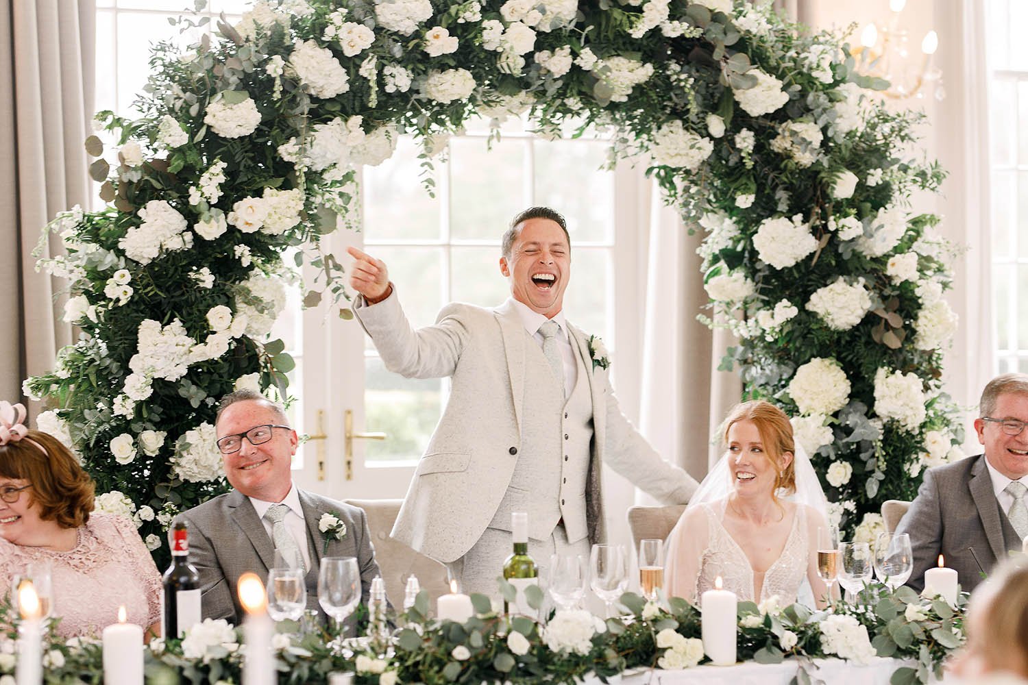 groom's speech in front of floral arch