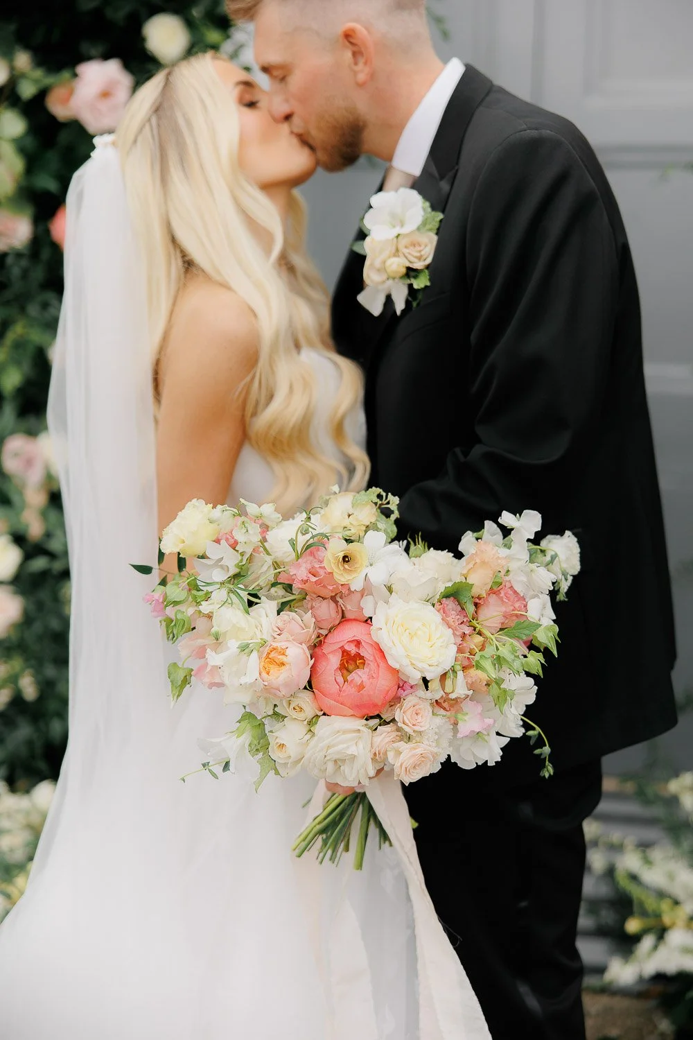 flower detail with couple kissing behind