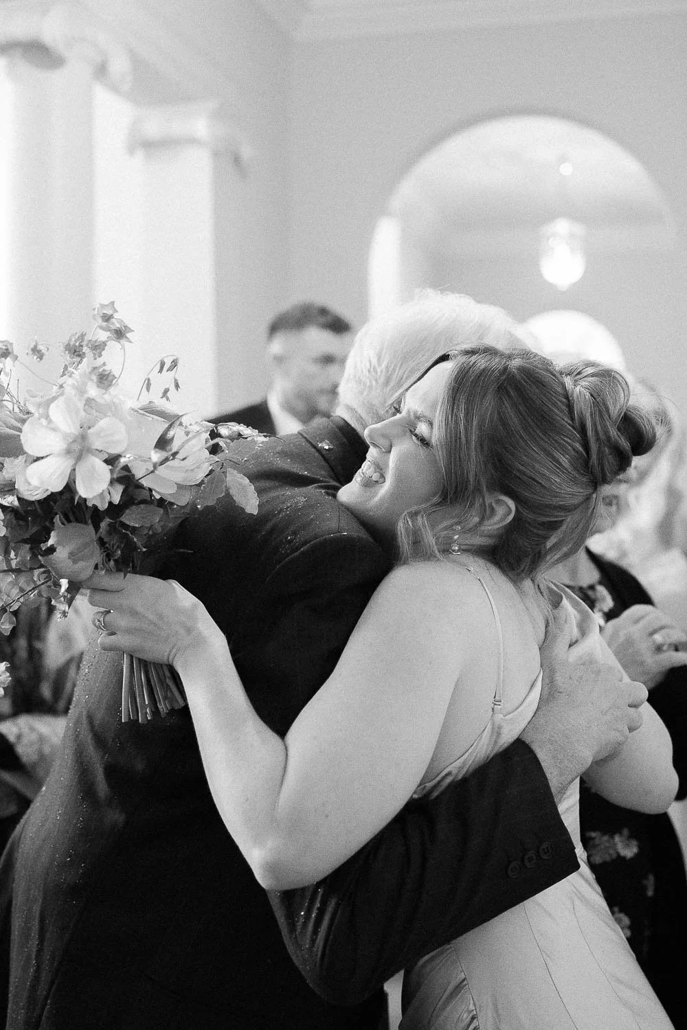 hugs and smiles at the wedding reception