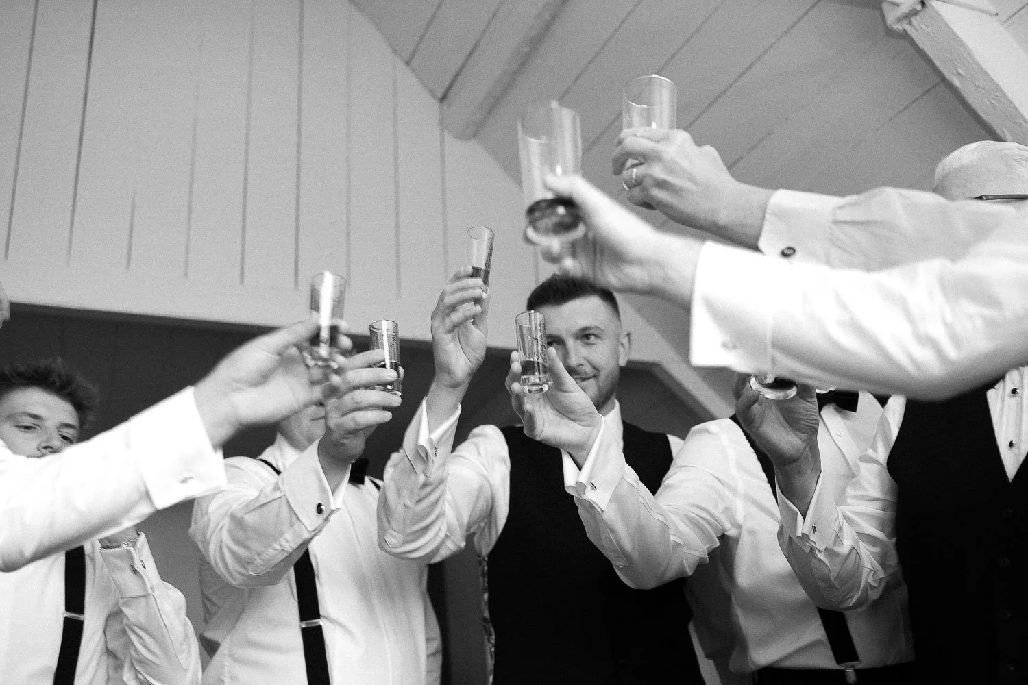 groomsmen with whiskey glasses in hand