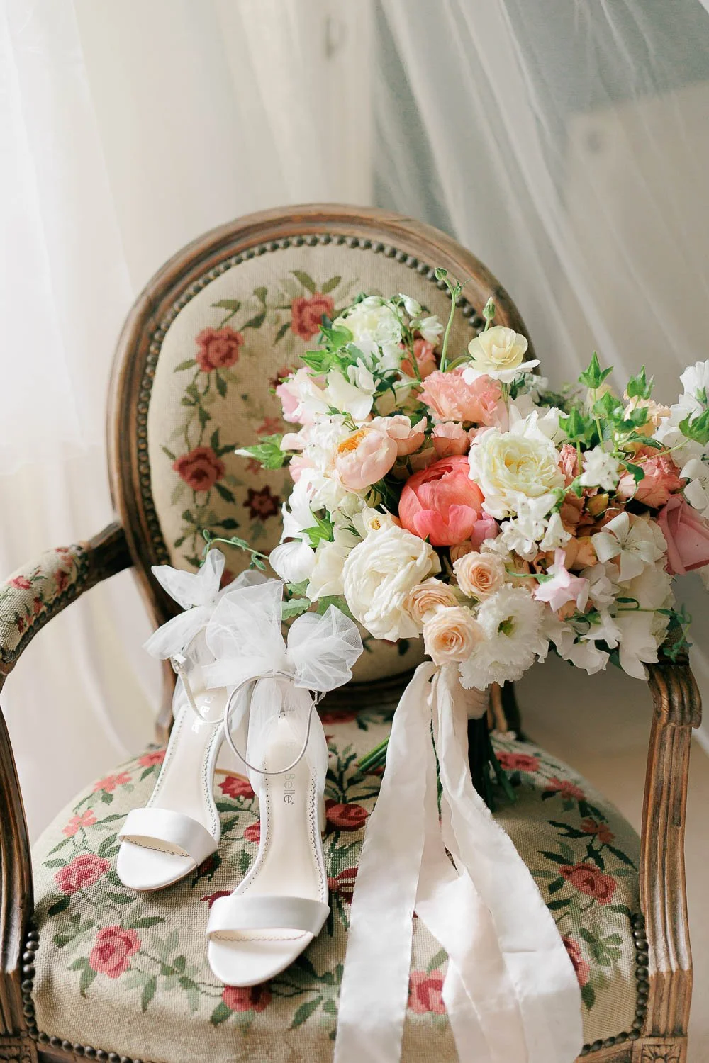 detail photo of brides shoes and flowers