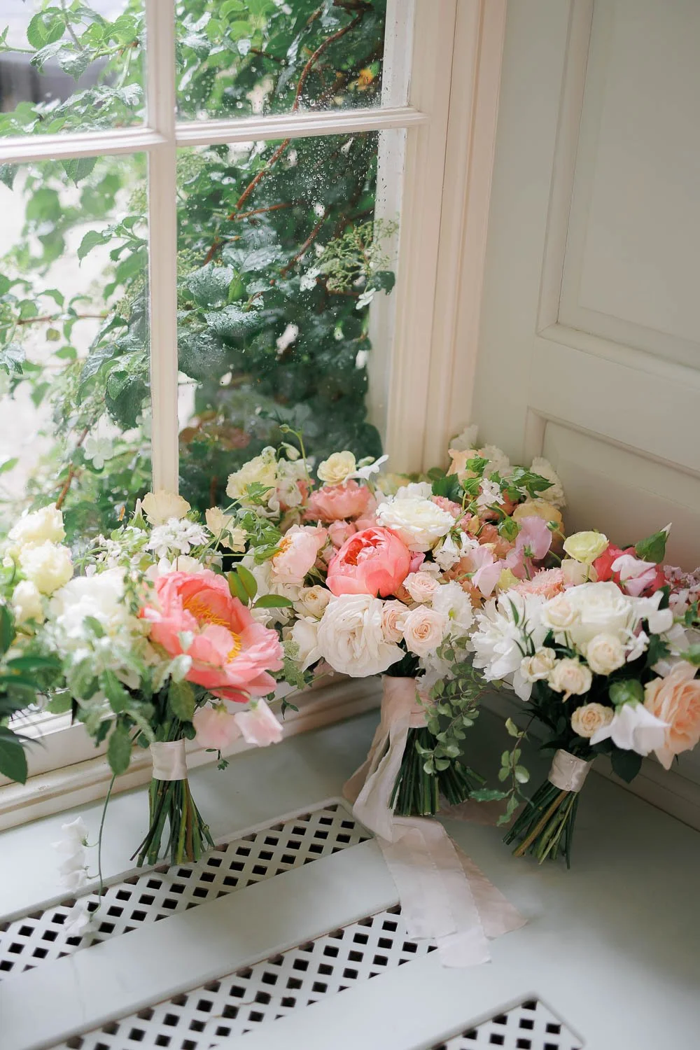 colourful bouquets placed on a windowsill indoors