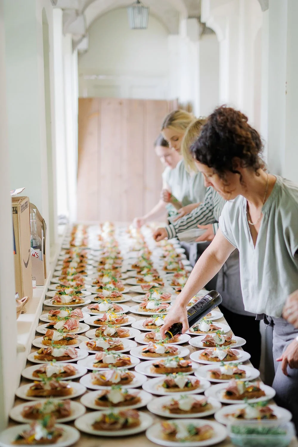 Catering team preparing many plates of food