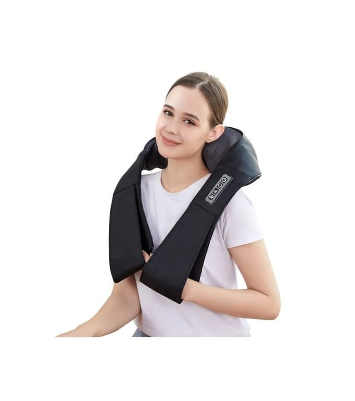 Young woman with light brown hair in a ponytail, wearing a white t-shirt, smiling slightly, sitting with a black massage or neck massager device around her shoulders and neck.