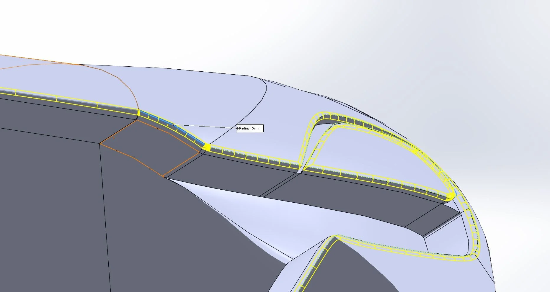 Surfaces are created within the boundaries of the splines and curvature is validated. Once patched into a solid volume fillets are added on any edges.