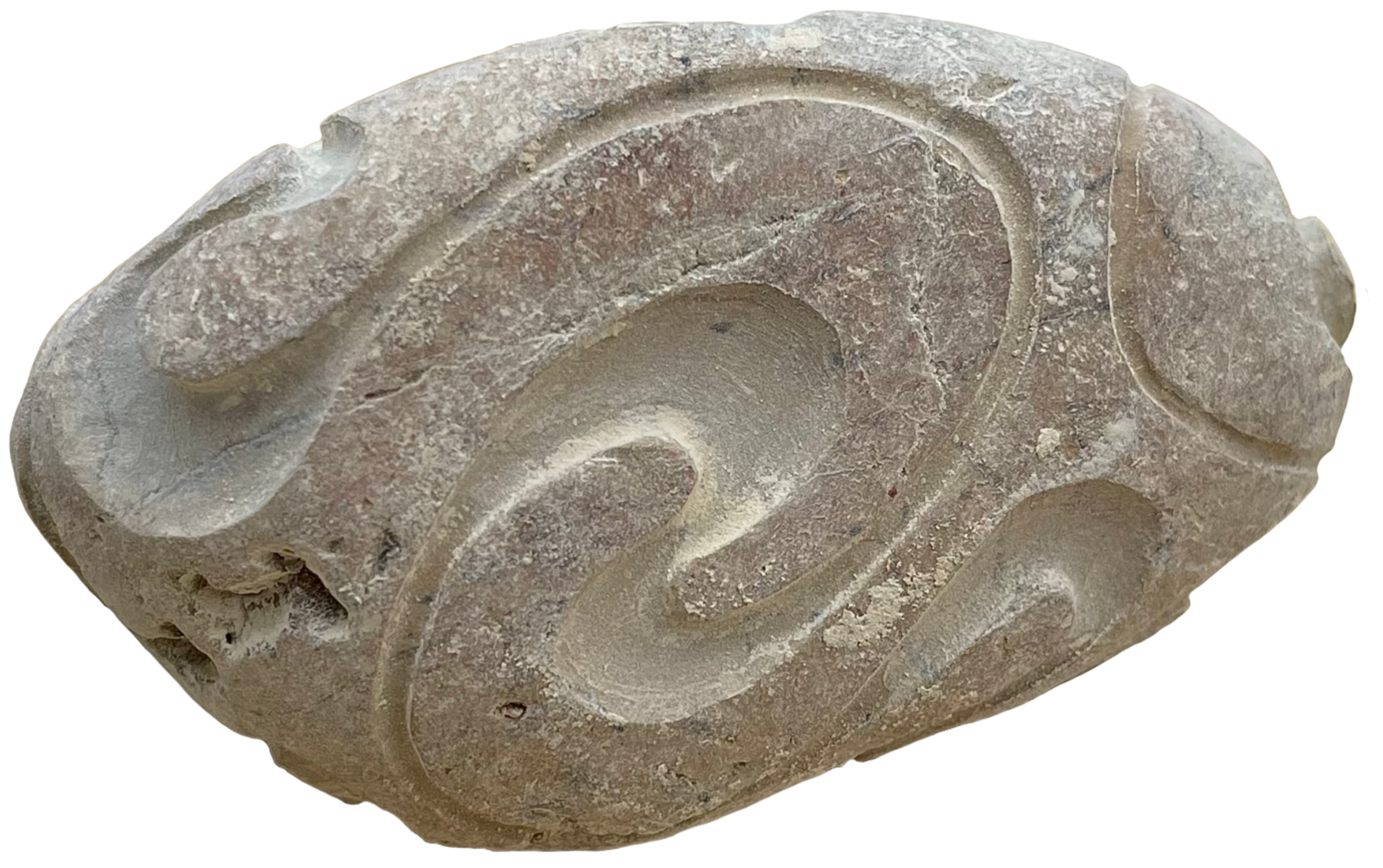 Close-up of a carved stone or ceramic object with swirling pattern decorations.
