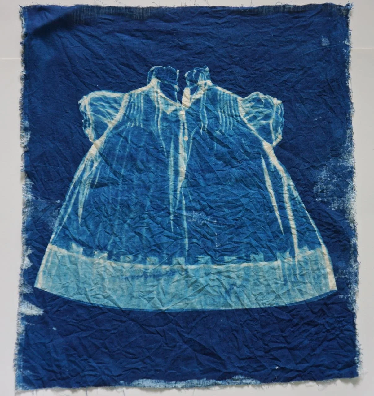 cyanotype of child's dress on linen