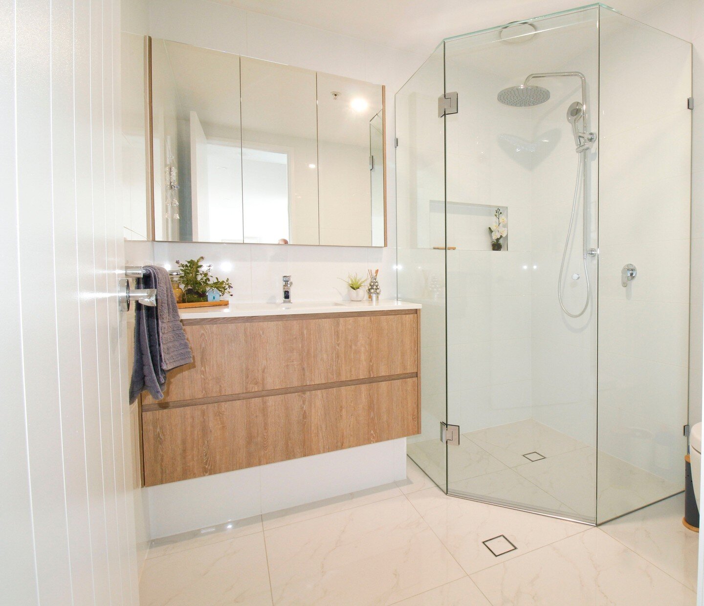 Here is the main bathroom in our Gold Coast apartment.  While we weren't able to move services, we were certainly able to fully renovate the existing room to make it feel more open and spacious.  A frameless shower screen opening the space and the sh