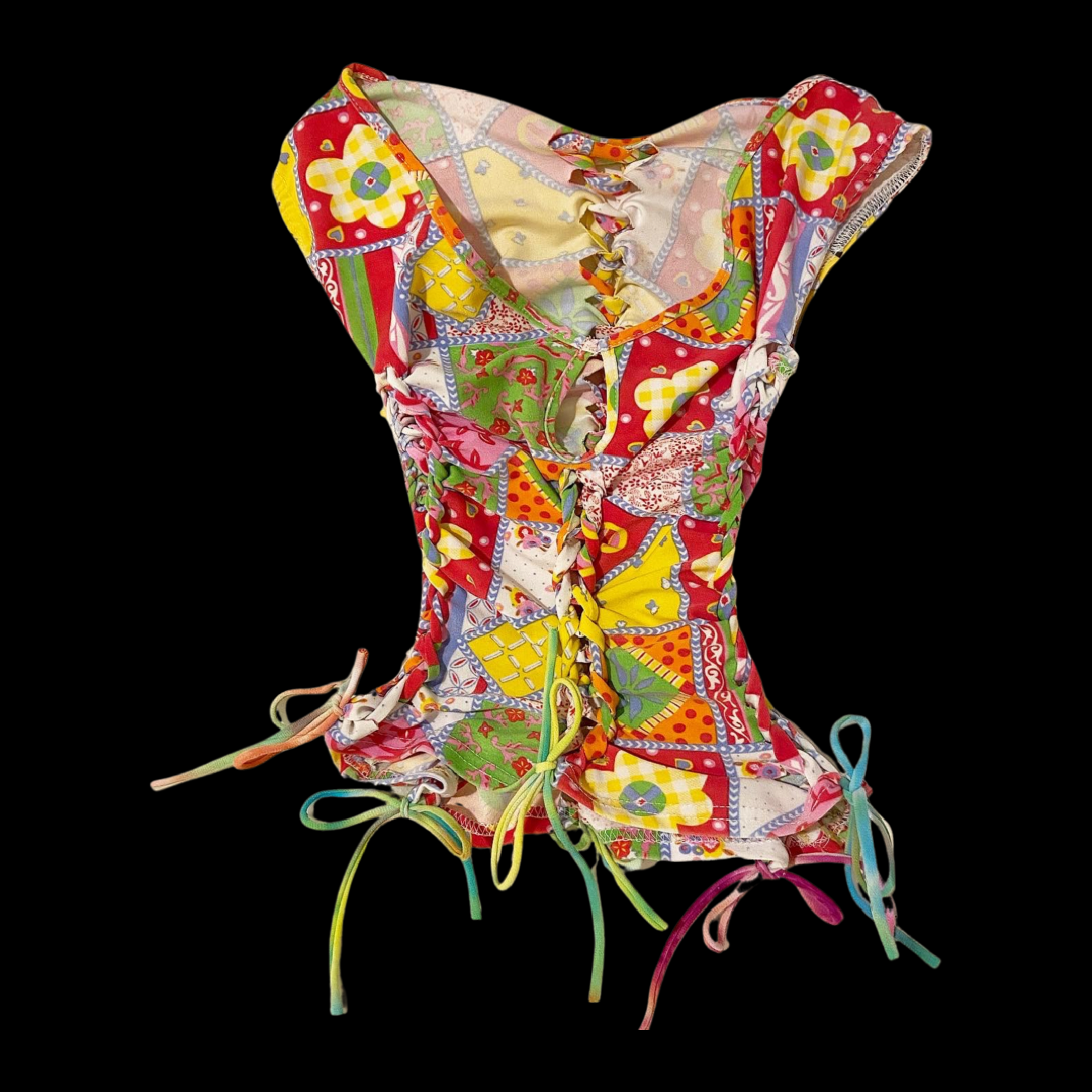 Colorful patchwork dress with ruffled, tied edges and multicolored laces on a black background.