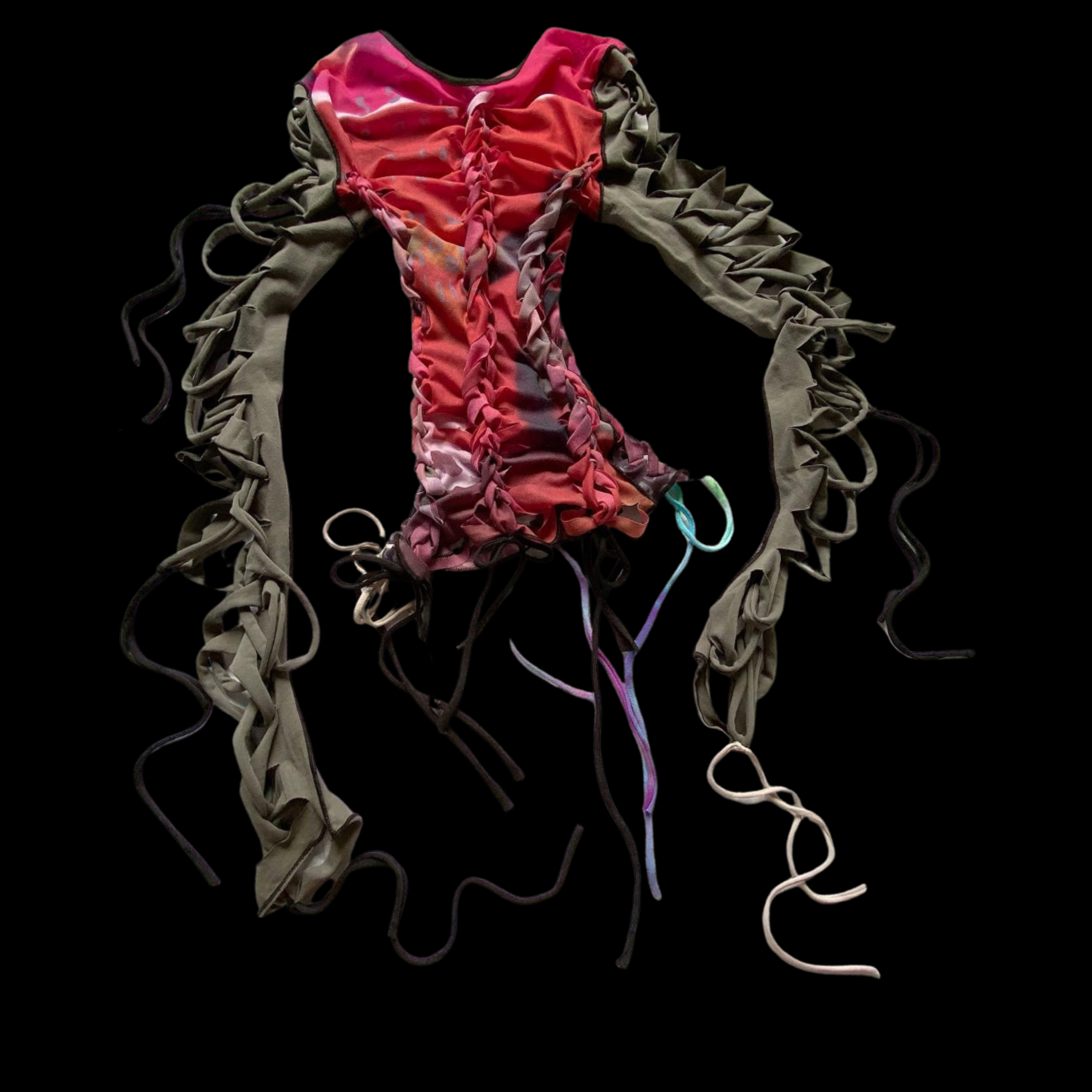 Colorful textile with braided fabric strips, drawstring details, on a black background.