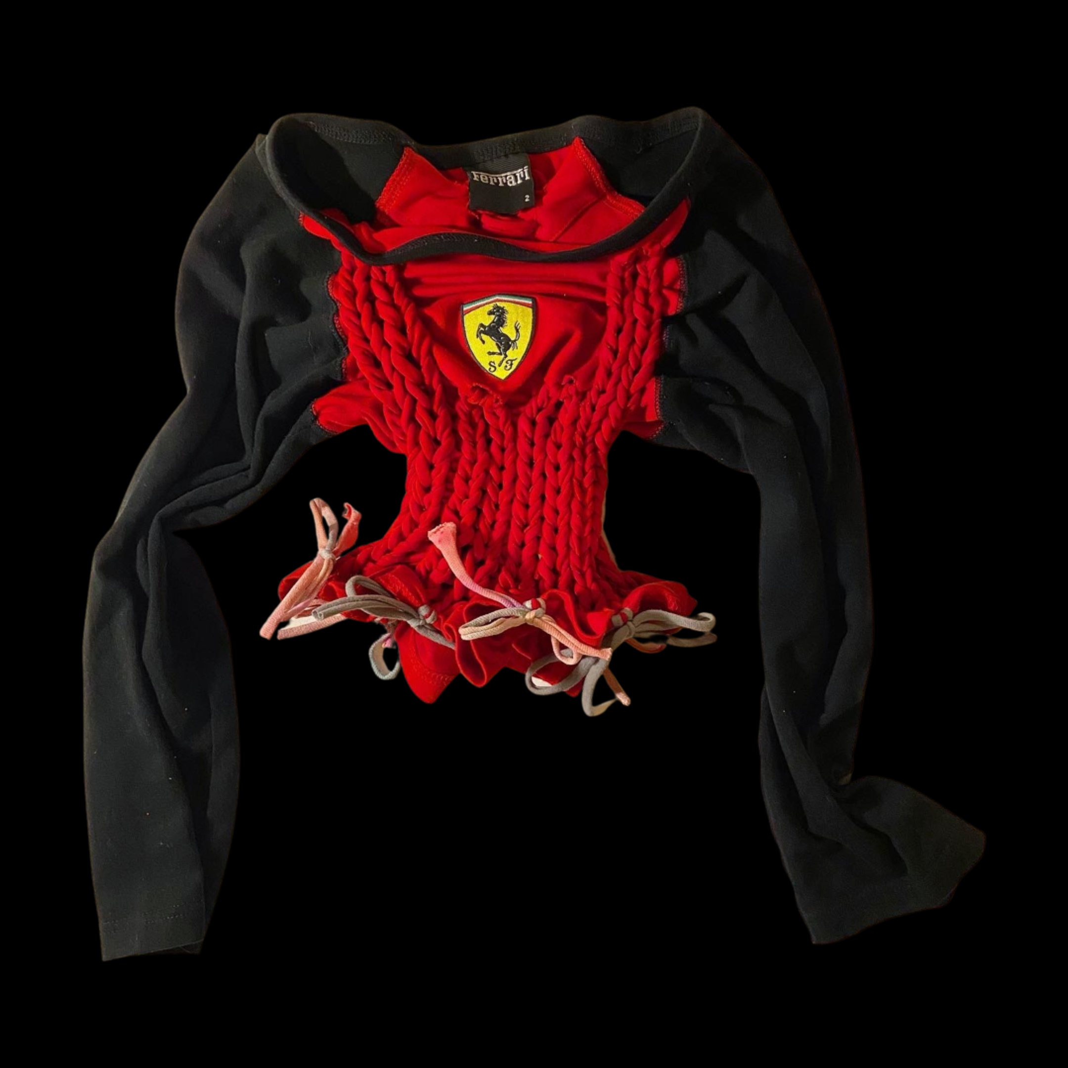 A Ferrari racing team scarf and neck warmer featuring the Ferrari logo, with red fabric and black sleeves, laid out against a black background.