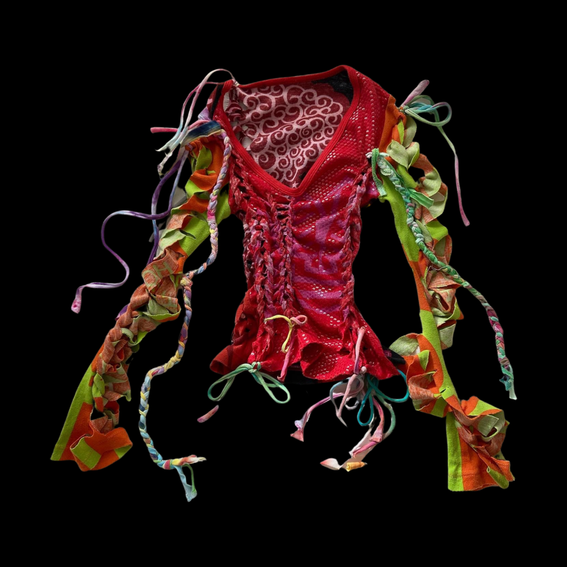Colorful patchwork shirt with drawstrings and ribbon details on a black background.