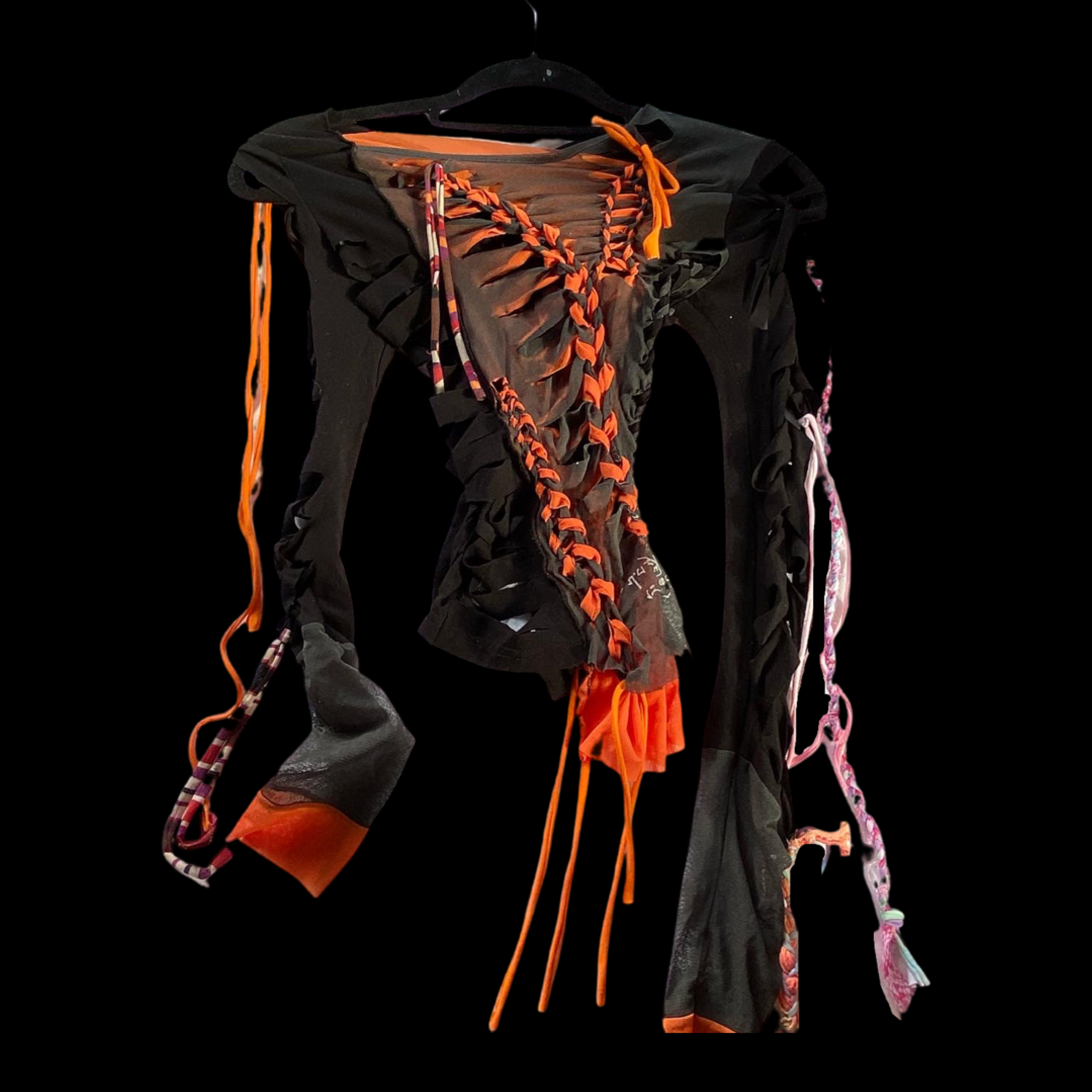 A black and orange sports harness or vest with colorful attached cords and straps, hanging on a black hanger.