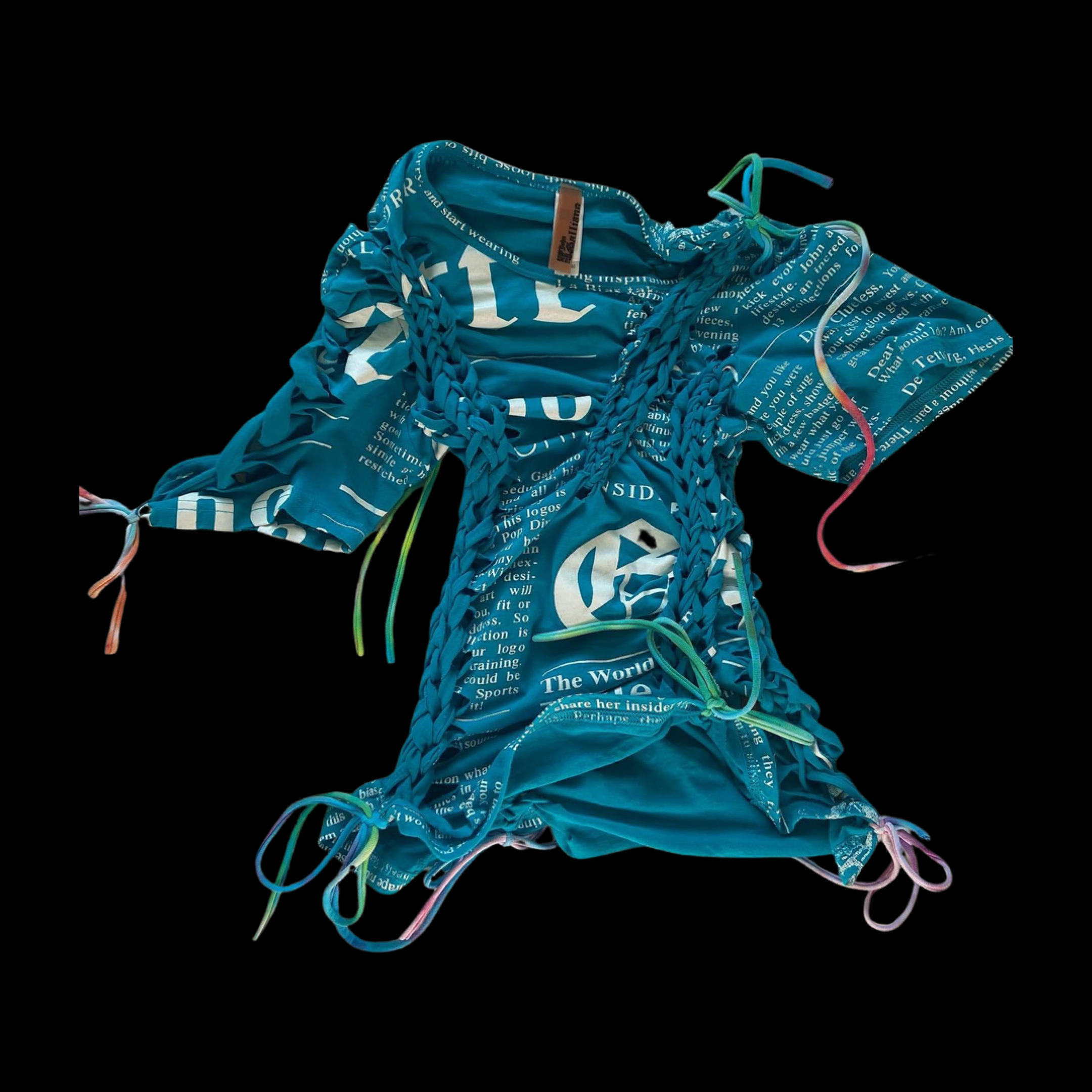 A crumpled blue fabric with white printed text, tied with multicolored strings, against a black background.