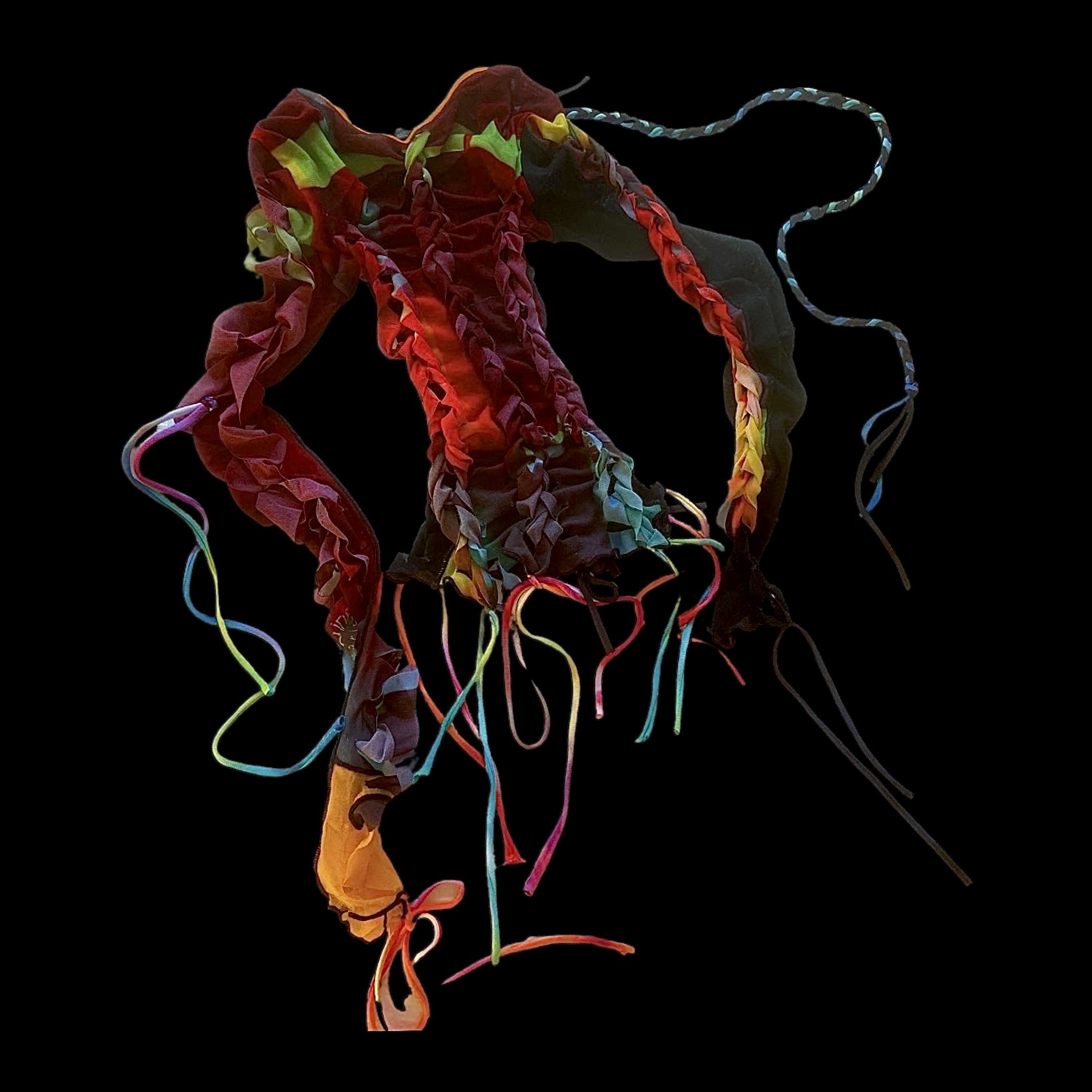 Colorful, tangled fabric or ribbon on a black background.