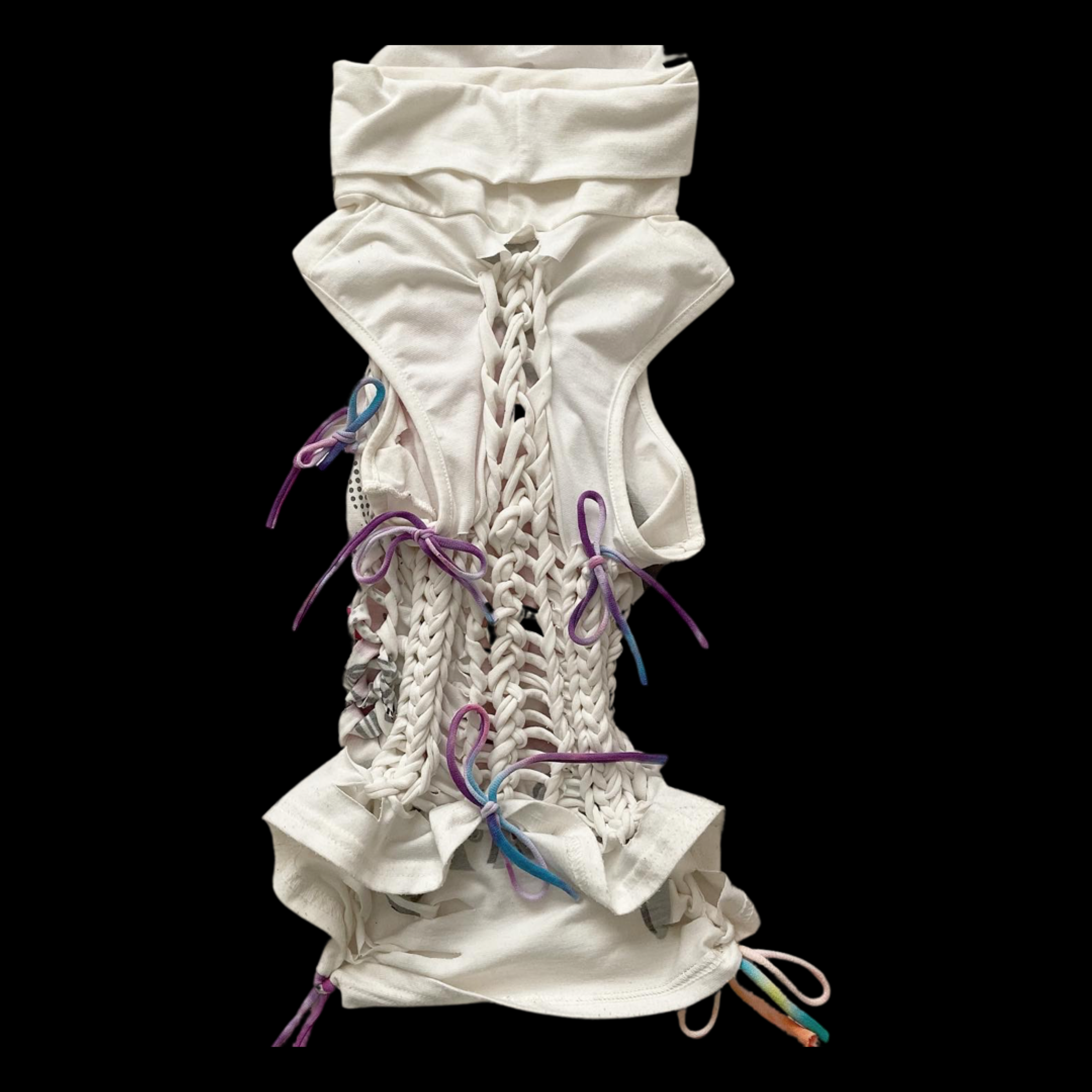 A white fabric corset with laced-up front and colorful shoelace-like ties, isolated on a black background.