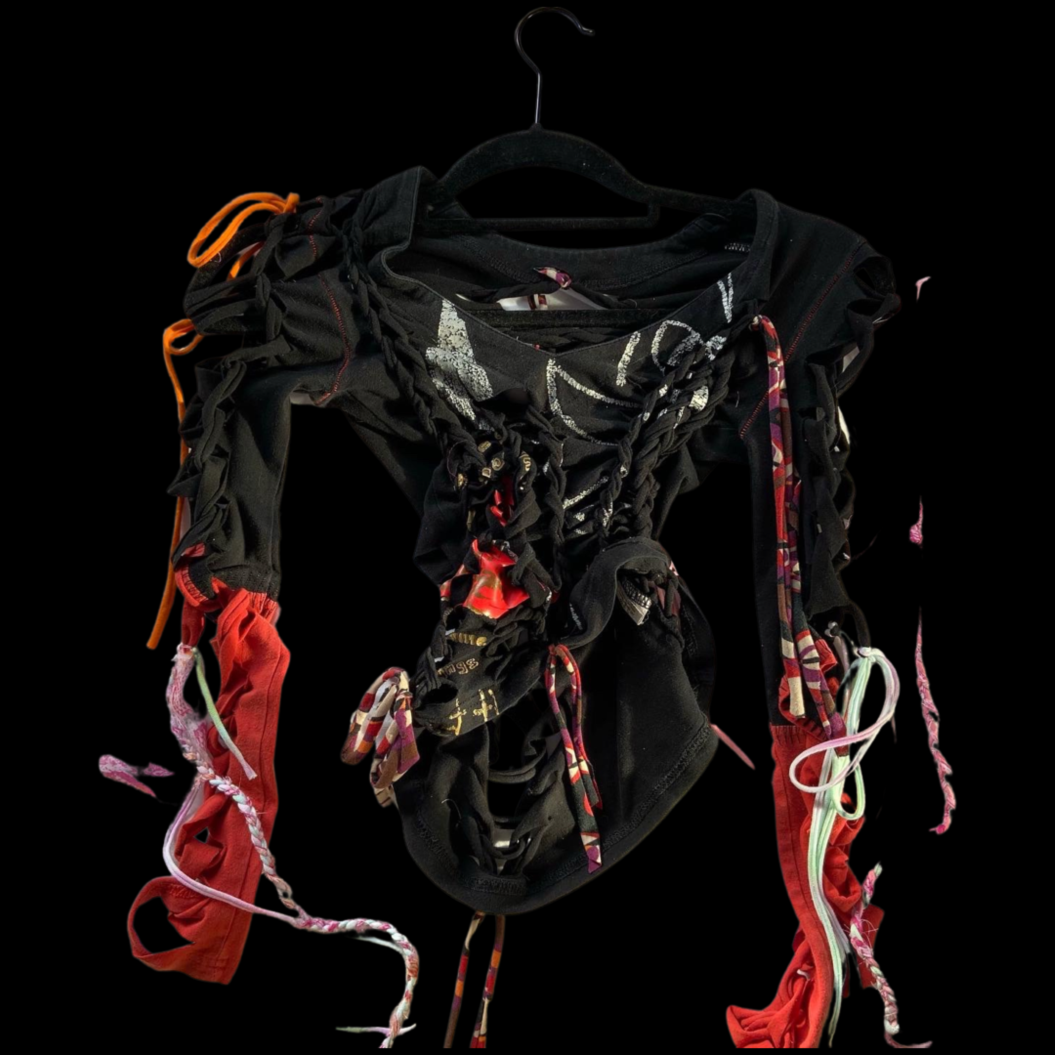 A black hanger holding a collection of black, red, and multicolored cloths and strings, featuring ties, knots, and fabric pieces against a dark background.