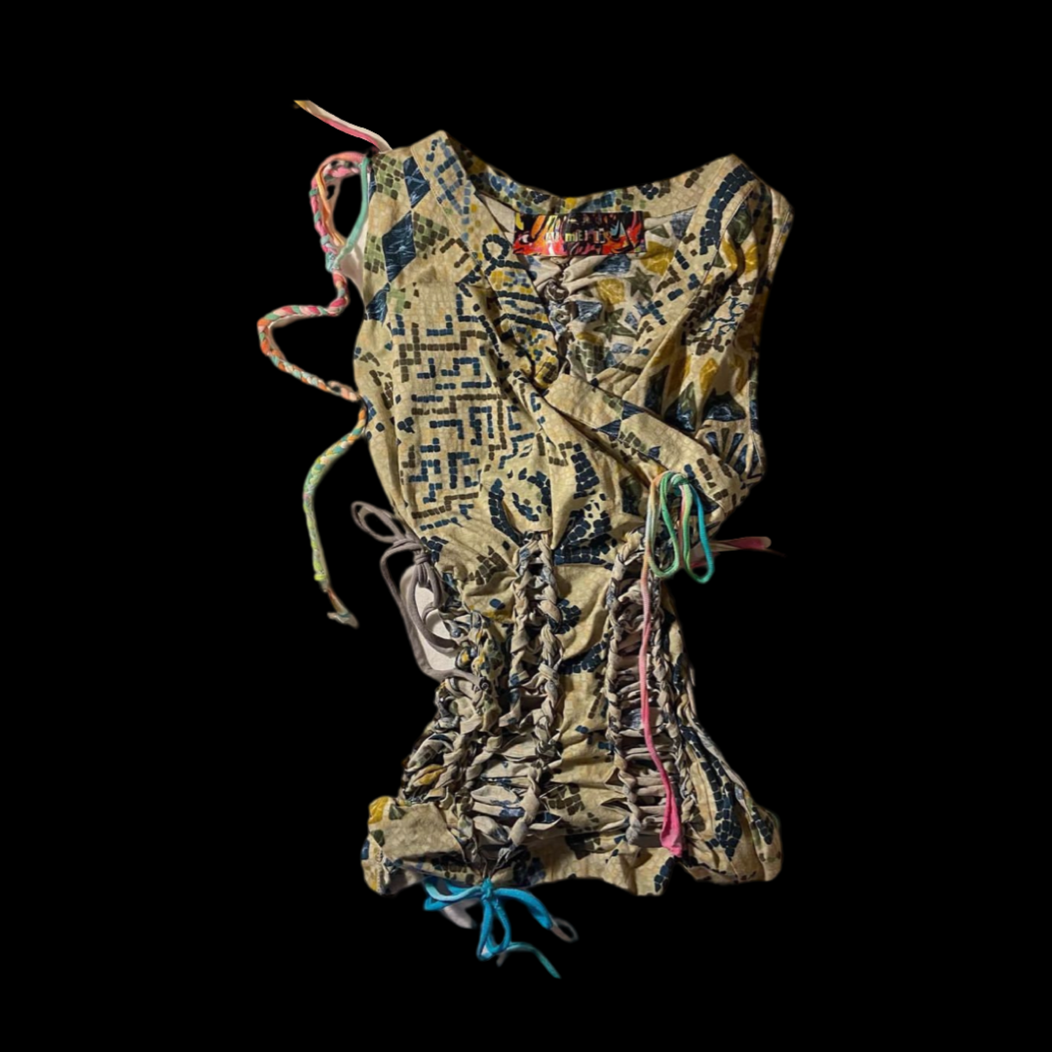 Colorful patchwork fabric with multicolored strings and ribbons on a black background.