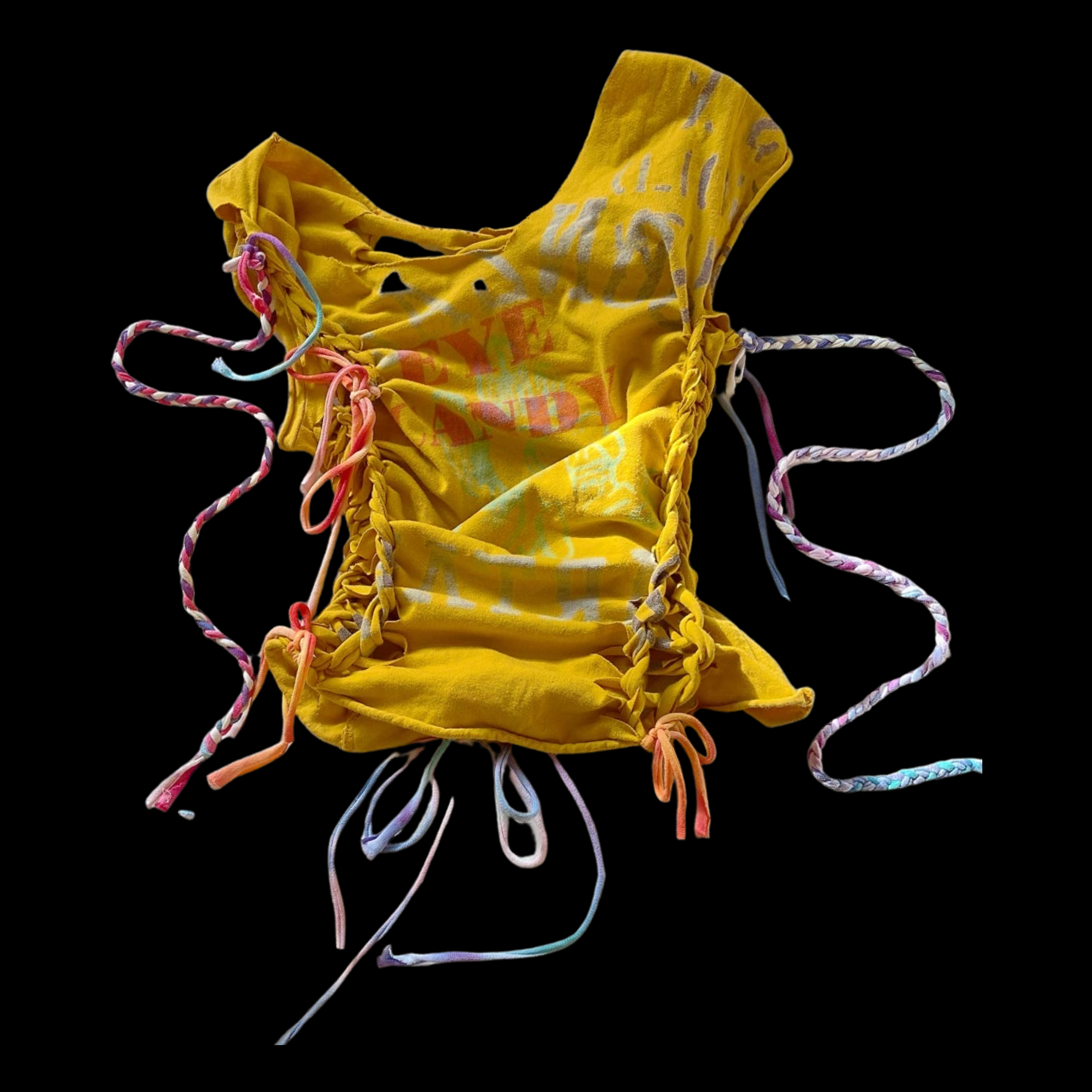 Yellow fabric mask with colorful strings and a printed design, isolated on black background.