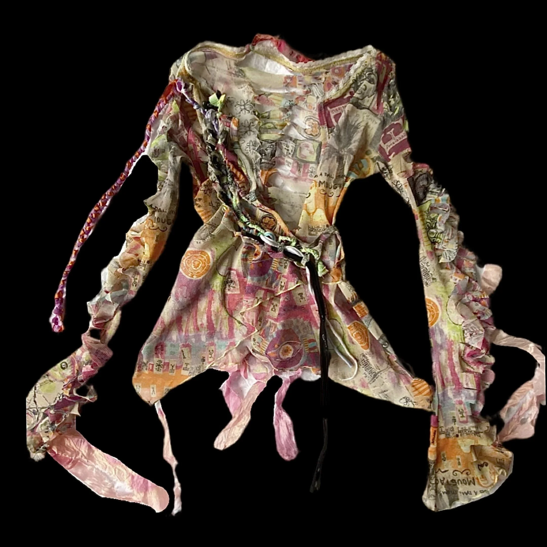 A colorful, crumpled piece of fabric with a collage of magazine or newspaper clippings, featuring various images, text, and patterns, arranged in a loose, flowing shape.