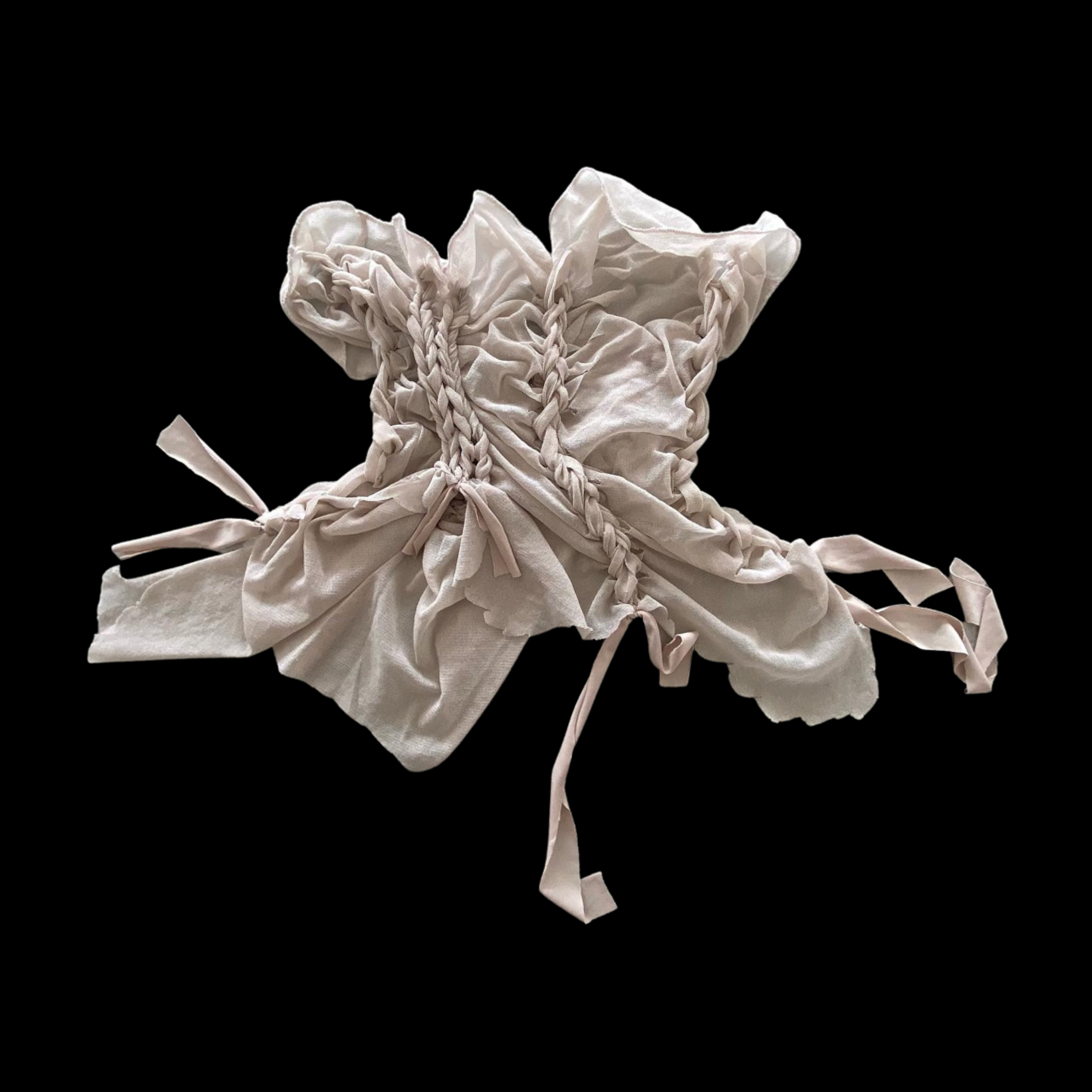 A crumpled, off-white fabric with braided strips on a black background.